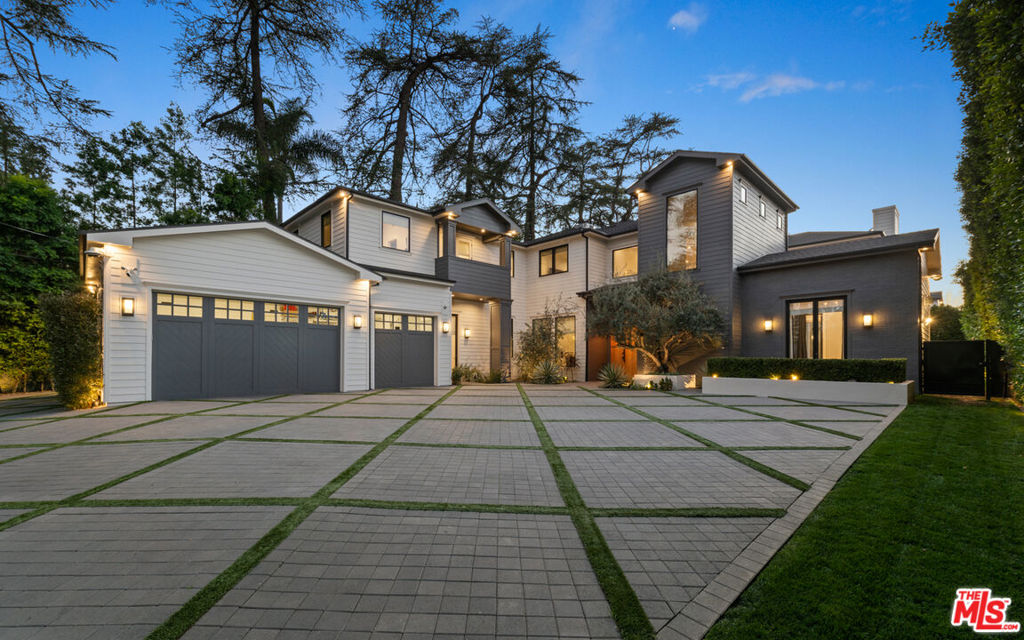 Modern Farmhouse Estate nestled privately South of the Blvd in Encino provides the ultimate luxury. 9,864 sq. ft. of luxurious living space w/ 7 spacious bedrooms & 7.5 bathrooms. Grand entry boasts ultra high ceilings & checkered marble tile welcomes you to the dazzling dining room w/ brass built-ins & a formal living room with marble fireplace & private patio. European oak wood floors guide you to the sophisticated family room w/ marble slab fireplace & wooden built-ins. Across is gourmet chefs kitchen with two stone islands, Wolf & Sub Zero appliances, & breakfast nook. Opulent primary retreat fts. a marble fireplace, custom built-ins, wine cooler, & spacious dual primary bathrooms and closets. Backyard oasis is complete with an outdoor kitchen, bar, pool & spa, fire pit with built-in seating. Spacious guest house features 2 bed & 1 bath with family room & kitchenette. This unforgettable home is located just minutes from Ventura Blvd's trendy shops & fine dining.