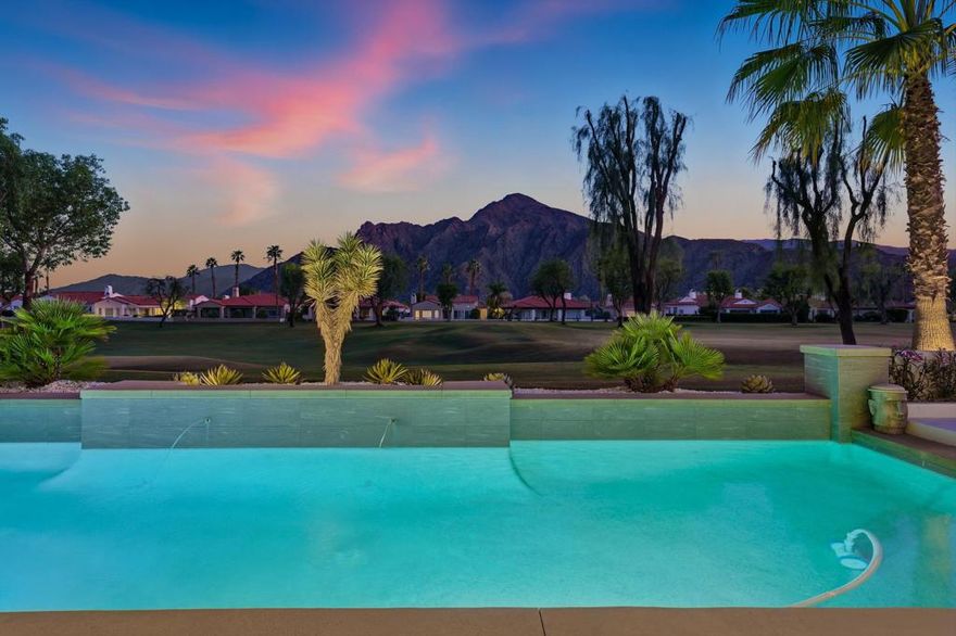 When Beauty Meets Perfection. Welcome to one of the most exquisite homes in The Citrus, where timeless design meets breathtaking views of the 15th fairway and the majestic Santa Rosa Mountains. Every inch of this residence has been artfully curated by renowned New York designers to create a seamless blend of sophistication, comfort, and effortless desert living. As you enter through the serene courtyard, a sculptural Mastic tree set among pristine white stones sets the tone for the understated elegance that awaits within. Beyond the wood double-entry doors, prepare to be captivated. The dining area is a true showpiece, framed by a stunning picture window with custom wood shades and light-wood built-in shelves and cabinets. The adjacent art studio is equally suited as a game room or intimate lounge. At the heart of the home, the great room flows seamlessly into the architecturally designed, high-end gourmet kitchen, where form and function meet in perfect harmony. A large island comfortably seats six beneath a custom cactus chandelier, while bespoke cabinetry  and panoramic views complete the space. The kitchen is equipped with Sub-Zero, Dacor, Fisher & Paykel, and Scotsman appliances, ensuring an elevated culinary experience. The great room features a sleek fireplace, hidden surround sound, large TV and flush drawers for extra storage, and stunning etc  panoramic views. The primary suite is a private retreat oriented toward the southern vistas, offering endless mountain views. The spa-inspired bathroom is pure indulgence--featuring dual walk-in showers, custom-built closets, imported concrete sinks from England, an alabaster ceiling fixture from Italy, and even a heated fan for ultimate comfort. Two additional guest suites, each with private bathrooms, offer luxurious accommodations for family and friends. The separate casita, located just off the courtyard, provides an ideal sanctuary for guests with its own coffee bar, built-in refrigerator, and en-suite bath. Step outside to a backyard paradise, designed for both relaxation and entertainment. A new pool (2019) and sunken spa invite you to unwind while enjoying unobstructed southern views. You will be admiring the stars and sunset around the custom made fire-pit. Thoughtful landscaping with low white walls, Mexican pansies, flowering cacti, a mature lemon tree and kumquat trees, creates a serene, resort-like ambiance. Every element of this home has been meticulously considered. Furnished per inventory.
