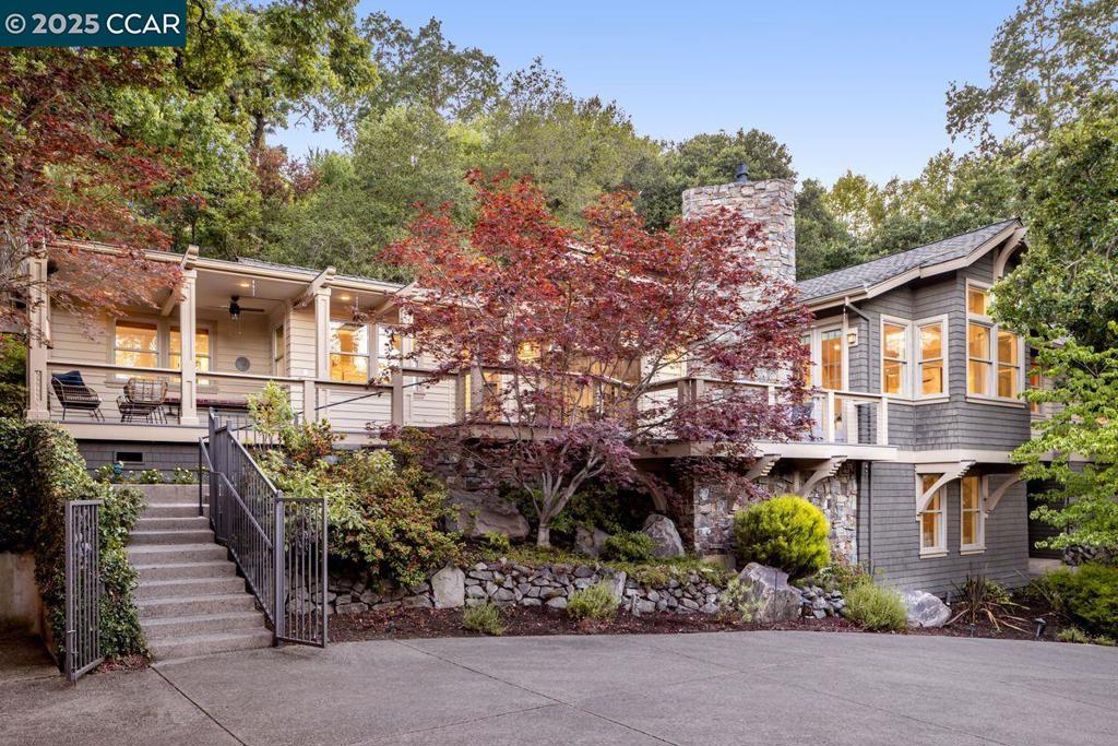 Tucked away near the end of a quiet cul-de-sac, this home offers elegant indoor-outdoor living just minutes from charming downtown Danville. Enter past twin water features into a foyer with 15-ft ceiling. The chef’s kitchen features marble counters, Miele and Wolf appliances, dual refrigerator-freezers, and a breakfast nook with garden views. The adjacent family/living room offers vaulted ceilings, a stone fireplace, and hidden Sony TV. Across the hallway, the formal dining room easily seats 10. Outside, enjoy a deck with DCS grill, pizza oven, and covered Pentair spa under mature oaks, palms, and Japanese maples. Three bedrooms, including the private principal suite with freestanding tub, lie on the main floor; downstairs, a spacious downstairs bedroom with en-suite bath could serve as a playroom or additional family room. The refrigerated wine cellar holds 864 bottles and completes the lower floor. A detached guest apartment, ideal for extended guest stays, an au pair residence, or multigenerational living, lies above the garage and offers a kitchen, full bath, separate bedroom, and walk-in closet. Ample parking completes this serene, tree-shaded property near the Iron Horse Trail and top schools.