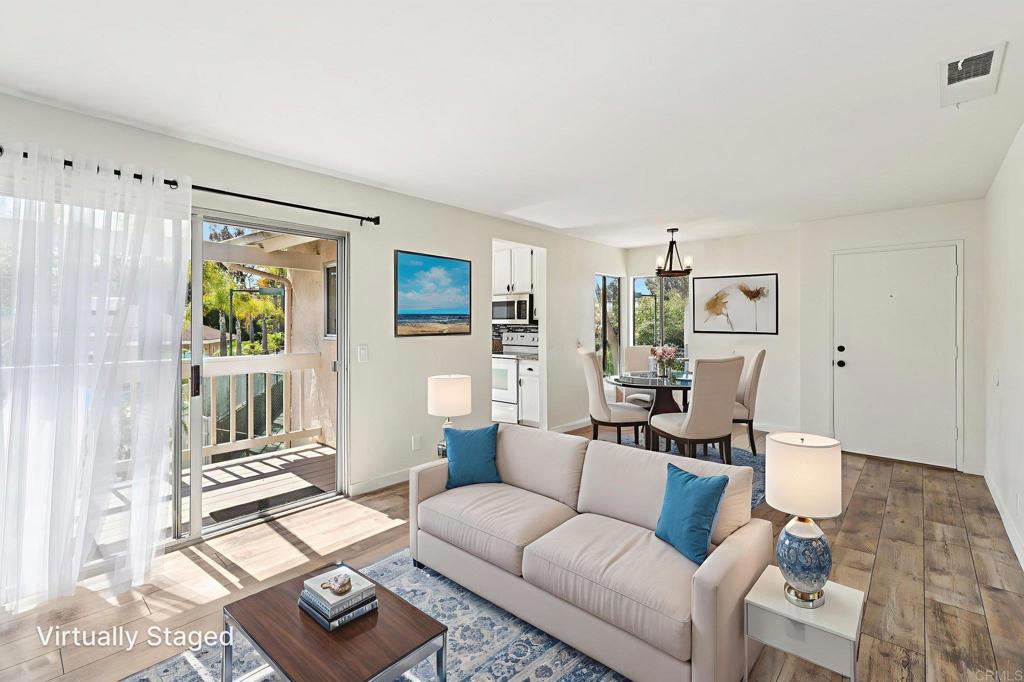 Welcome to this thoughtfully remodeled upper-level end unit condo, offering privacy, natural light, and serene views of the pool, tennis courts, and lush landscaping. This home is truly move-in ready, blending modern updates with inviting charm. Step inside to discover luxury vinyl plank flooring throughout and floor-to-ceiling mirrors in the living area that enhance light and depth, creating a bright and spacious feel. The kitchen features solid-surface countertops, a brand new dishwasher and microwave, and abundant cabinet space—perfect for home chefs and entertainers alike. The primary bedroom enjoys tranquil views of the pool and surrounding greenery, where local birds make their home, adding a peaceful touch to your mornings. The fully remodeled en-suite bathroom includes a walk-in shower and tasteful designer finishes. A secondary bedroom, also filled with natural light and beautiful views, is serviced by a second fully renovated bathroom, ideal for guests or a home office. Generous closet space is found in both bedrooms, along with additional storage throughout the unit. Enjoy your morning coffee or evening cocktail on the private deck just off the family room—an ideal spot to relax and unwind. A dedicated laundry closet with washer and dryer adds convenience, and the unit also includes a detached one-car garage. This well-maintained community offers resort-style amenities, including a sparkling pool, hot tub, tennis courts, and a fully equipped gym. Ideally located just off Hwy 78, with quick access to I-5 and I-15, this home places you within easy reach of local beaches, shopping, dining, and everything San Diego has to offer.
