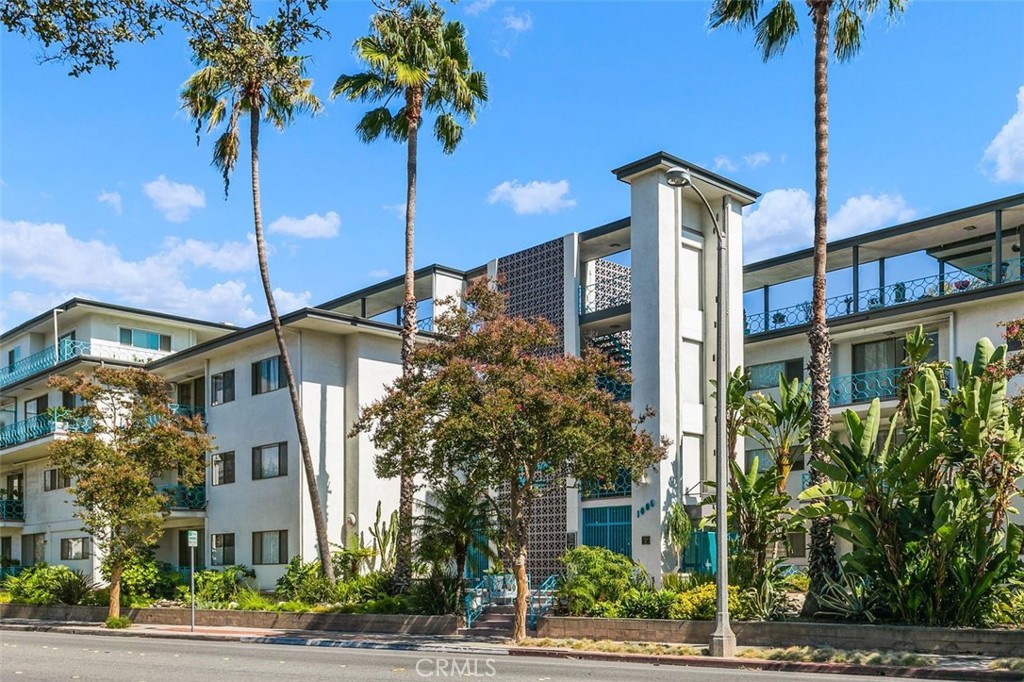 Whispering Waters, c. 1960, a Pasadena Historic Landmark and one of the area's most beloved Mid-Century Modern properties, was designed by noted developer Lionel V. Mayell with views of the San Gabriel Mountains and city life right outside. This Mid-Century Modern gem is located just off the renowned South Lake Avenue shopping district. This is an end-unit on the ground floor with TWO bedrooms and TWO bathrooms that have been updated and remodeled. Floor-to-ceiling glass doors invite sunlight to brighten any day. All this within +/- 1,200SF of living space. Need storage? Oh, so much storage here with shelving, drawers, and closets! The north-facing patio offers views of the San Gabriel Mountains and evening sunsets. The bright and updated kitchen offers plenty of room to whip up a fantastic meal. The underground parking offers your very own garage! The garage has enough space for a single vehicle and room for overflow storage. Enjoy easy access to Pasadena's most popular shopping, dining and cultural institutions. Caltech, PCC and so much more are just outside your secured and gated front door. Water utility is included in HOA fees. The Mills Act designation offers owners reductions on annual property taxes. This is a rare opportunity to live in a space that makes Pasadena famous. Come live in a landmark!