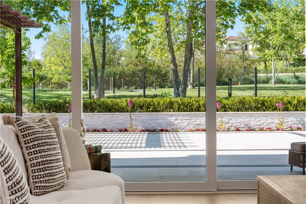Park Views, Prime Location, and Unmatched Elegance | Welcome to the prestigious 24-hour guard-gated community of Altair Irvine. This south-facing estate is ideally situated on one of the most premium lots, directly bordering a lush greenbelt. Enjoy unobstructed park views from the first floor, second floor, and the beautifully landscaped backyard—like living inside a dynamic work of art seamlessly blended with the home.
A private gated entry leads to a thoughtfully designed front yard and courtyard, offering both privacy and timeless curb appeal. The home also includes a spacious three-car garage, ideal for car lovers or flexible multi-purpose needs.
Inside, every corner showcases Extensive Designer Upgrades, from wide-plank hardwood floors to a bright, airy layout that maximizes natural light and elevates comfort. The chef’s kitchen boasts a waterfall-edge quartz island, floor-to-ceiling cabinetry, and top-tier stainless steel appliances, flowing into an expansive great room and formal dining area overlooking a peaceful courtyard.
The main level includes two en-suite bedrooms, including a private-entry guest suite ideal for multigenerational living or extended stays. Upstairs, the luxurious primary suite features dual vanities, a large walk-in shower, and two custom walk-in closets. The primary bathroom is richly appointed with marble finishes, creating a true spa-like retreat. A generous loft and bonus room offer flexible space for a home theater, gym, or game room, while a large covered terrace nearby provides the perfect setting for relaxing or entertaining.
Step outside to your private backyard oasis, complete with a built-in BBQ, mature fruit trees, and sweeping greenbelt views—perfect for hosting guests or enjoying quiet evenings at home. All within walking distance to Altair’s resort-inspired clubhouse, featuring pools, tennis courts, playgrounds, scenic trails, and more.
Move-in ready and sure to impress—book your private tour today before it’s gone.
