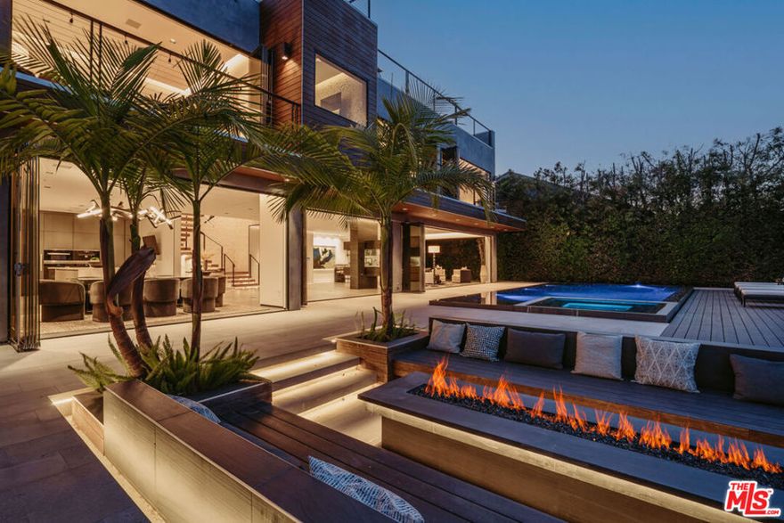 Welcome to "The Encino Observatory" an architectural masterpiece with jetliner unobstructed valley views and expansive rooftop deck conveniently located on one of the best streets and vantage points in all of the prestigious Encino Hills. The meticulously designed interior features top-of-the-line finishes, including a Miele kitchen with an elegant Onyx bar, a 100-bottle wine cellar, soaring ceilings adorned with a striking 20ft chandelier, Crestron smart home automation, and bespoke LED lighting throughout. Step through floor-to-ceiling panoramic glass doors to discover an entertainer's dream backyard, complete with an infinity pool, spa, outdoor fire-pit, and utmost privacy. Indulge in the opulent and Bali inspired primary suite boasting a designer-done bathroom, wet bar, and expansive walk-in closet. Ascend to the expansive rooftop deck and immerse yourself in arguably the finest views Encino Hills has to offer. Equipped with Crestron home automation and top-tier security systems, this residence offers both convenience and peace of mind. With close proximity to the vibrant amenities of Ventura Blvd, this estate presents a golden opportunity to experience the epitome of luxury living in absolute tranquility. Truly an architectural masterpiece awaiting the most discerning of buyers in all of Encino.