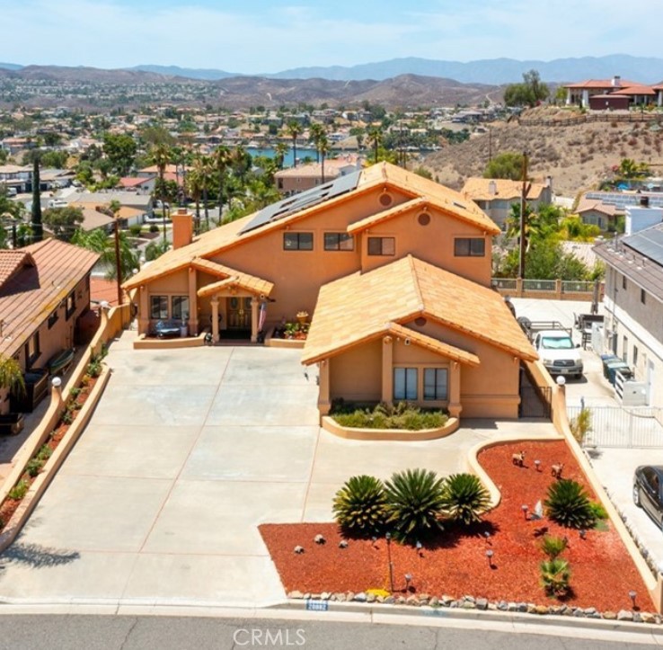 Beautifully upgraded Canyon Lake home offering a spacious layout, private pool, RV/boat parking, and paid-off solar panels. This expansive residence is situated on a large lot and features an open-concept floor plan with antique grey wood-look tile flooring throughout the main level. Abundant windows provide natural light and highlight the seamless indoor-outdoor flow.
The main living area opens to a covered veranda overlooking the pool, ideal for relaxation and outdoor enjoyment. The kitchen has been recently updated with quartz countertops, tile backsplash, and freshly painted cabinetry. A custom home office nook with glass-inlay cabinetry adds functionality to the space.
Downstairs includes a Jack-and-Jill bedroom suite with a full bath featuring dual vanities, soaking tub, and separate walk-in shower. Wide hallways lead to a remodeled powder room, large laundry room, and direct garage access with no steps.
Upstairs, a spacious loft serves as a second living area or game room with skylights, a wet bar, and access to an oversized balcony with lake views. The primary suite offers vaulted ceilings, a private balcony with spiral staircase, an en suite bath with dual vanities, walk-in shower, sunken jacuzzi tub, and a large walk-in closet with built-in shelving. An additional upstairs bedroom provides further flexibility.
The backyard features a sparkling pool, dog run, and generous patio space. Additional highlights include a three-car garage with epoxy flooring and workbench, extra attic and storage space, extensive flat driveway parking, and room for RV or boat storage. Fresh landscaping completes this well-maintained property.
Located within a gated community with access to a wide range of amenities including a private lake, golf course, parks, sports courts, clubhouse, and community events. A brand-new pump track is currently under construction, enhancing the area’s appeal.