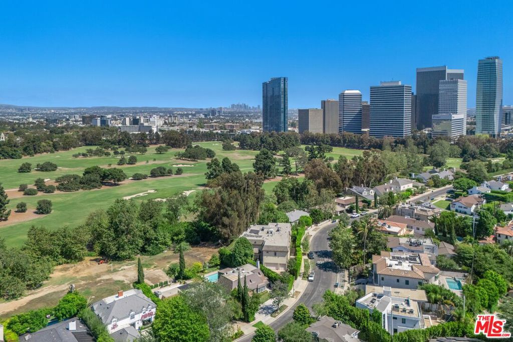 Set directly on the Golf Course of Los Angeles Country Club, this spacious home offers over 4,000 sqft of living space with 4 bedrooms and 4.5 bathrooms. Designed with both everyday living and entertaining in mind, the property blends comfort, convenience, and some of the most scenic surroundings in the city. The main level features a bright living room, formal dining area, and kitchen that flow seamlessly onto a large deck overlooking the backyard, large pool, and the golf course; creating an inviting space for hosting gatherings or simply relaxing outdoors. Upstairs, you will find two large en suite bedrooms and an enclosed glass sunroom with sweeping backyard and golf course views; ideal for an office, studio, or gym. The lower level includes a versatile space with its own entrance, kitchenette, and full bath, great for a guest suite or theater. Situated in an unbeatable location just minutes from Beverly Hills, Century City, and Westwood, this property places you at the center of it all while maintaining the peace and privacy of a golf course setting. Truly one of a kind in this price point. All offers due Monday September 22nd by 5:00PM.