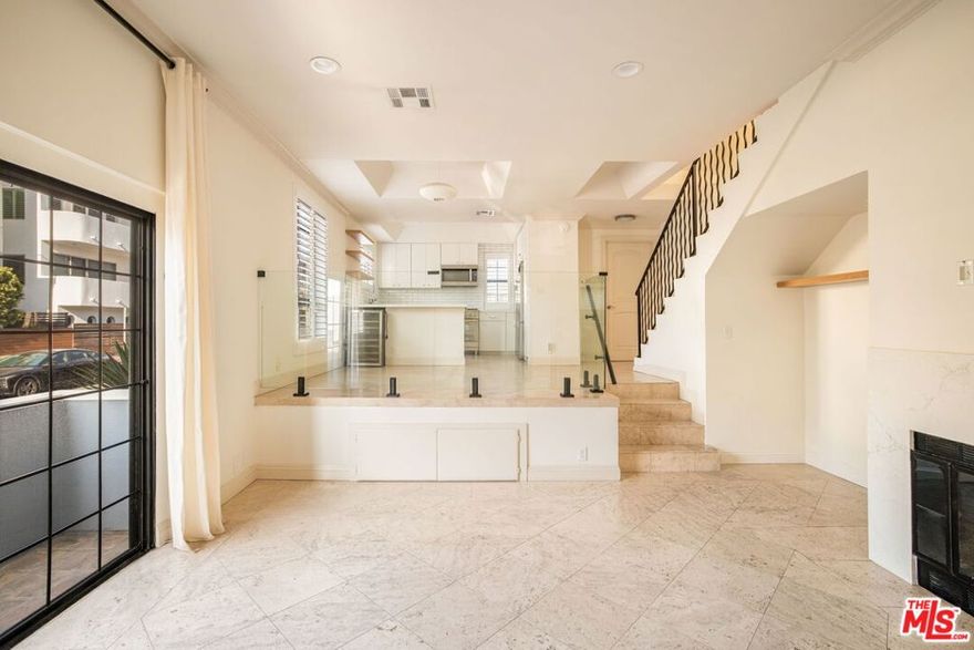 Just steps from the sand, this 2 bed, 2.5 bath Venice condo offers coastal living at its finest, featuring abundant natural light, high ceilings, and a beautifully updated kitchen and remodeled bathrooms. Enjoy a spacious living area on the lower level with a fireplace, private balcony, remodeled powder bathroom, and a convenient coat closet. The chef's kitchen is equipped with brand new appliances, a wine refrigerator, and a dining area. Upstairs, the primary bedroom boasts vaulted ceilings and newly built in custom closets with ample storage. The ensuite primary bathroom features a dual vanity and has been thoughtfully modernized with contemporary finishes. The second bedroom has its own private balcony with a peek-a-boo ocean view and ensuite bathroom. Additional highlights include two side-by-side parking spaces in a controlled access subterranean parking garage as well as gated, controlled entry to the building. A rare opportunity to enjoy modernized living just moments from the best of Venice Beach, dining, shops, and the bike path.