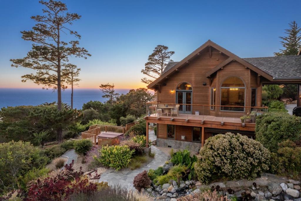 Welcome to 24 Mentone, where panoramic ocean views meet a beautiful mountain setting, all just 10 minutes from downtown Carmel. Every room in this custom-designed home offers breathtaking and inspiring views. The indoor-outdoor living experience is enhanced by multiple decks and patios, ideal for enjoying early morning coffee or evening sunsets over the Pacific. As one of the Monterey Peninsula's first timber frame designs, this property features unique architectural interest and provides a warm, inviting environment perfect for gathering with friends and family. The two-sided stone fireplace will warm the coolest nights. The main house includes 4 bedrooms and 2.5 bathrooms. The open gourmet kitchen is the heart of the home and an entertainer's dream, spacious enough for multiple chefs to cook while others enjoy the expansive views and open-concept living area. The 3.1-acre property features a fully functional 1-bedroom, 1-bathroom ADU, private beach access, hiking trails, a koi pond, a bocce court, and more. Whether you're observing wildlife in Mal Paso Canyon or watching whales migrate across the horizon, 24 Mentone Drive offers endless entertainment and functionality.