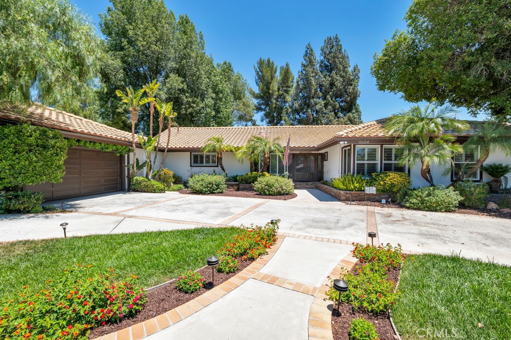 Your Staycation Comfortable Lifestyle Begins Here!*Spanish Style Single-Story Ranch meets Modern Farmhouse flair.Remodeled dream home, set on apprx 1/2 acre. A circular driveway and meandering walkway greet you with a soothing fountain and lush, mature landscaping. A double wrought iron-accented front door, flanked by operable side lights, welcomes you into this breathtaking home. 2 stone-accented fireplaces—1 featuring Fireglass,the other wood-burning—adorn the open-concept living & dining rooms. Your eye is immediately drawn to the backyard views through two sets of double-wide sliding glass doors.A set of beveled glass pocket doors leads to a private home office, allowing you to close it off for focus or open it to flow seamlessly with the rest of the living space—perfect for today’s work-from-home lifestyle.Recently remodeled cook’s kitchen features high-end stainless steel appliances, a Thor Professional Range and D/W, LG Double Convection Ovens, sleek tile backsplash, and expansive quartz countertops with a peninsula that comfortably seats 5. FLOW-motion sensor faucet, Rev-A-Shelf pullouts and organizers, and enormous walk-in pantry with a striking glass barn door. The Butler’s Pantry adds floating shelves, quartz countertop, and a microwave drawer.The guest bath includes a copper sink.Laundry room w/cleaning pantry & cabinetry. The 2nd bath features amber vessel sinks, a separate tub and shower accented by tumbled travertine, quartz counters/tub surround. All closets are upgraded with mirrored wardrobes and custom organizers.The spacious master suite is privately tucked at the rear of the home, featuring a coffered ceiling with mood lighting, ceiling fan, and separate over-the-bed lighting with dual controls. A spa-like master bath boasts a spa tub, separate subway-tiled shower with glass accents, + expansive walk-in closet with floor-to-ceiling organizers. Designed with entertaining in mind, the backyard features a Pebble-Tec pool with built-in seating, decorative tile, and elegant Bouquet Canyon Stone decking. A vaulted ceiling patio easily seats 8, while the covered patio includes ceiling fans and a TV. Gather around the Fireglass firepit on cool evenings for the perfect outdoor ambiance. Beyond, enjoy bocce ball or cornhole under a canopy of mature fir trees. Multiple seating areas, lush gardens, and a waterfall-accented pond make this yard feel like your own private resort. Gated RV access, parking for 2 additional vehicles, + 2 storage sheds.