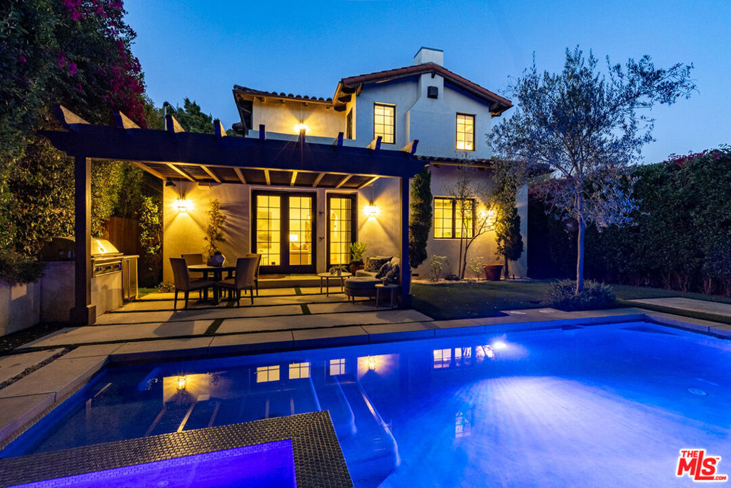 Discover the elegance of modern living at 735 North Stanley Avenue, Los Angeles an exquisite Spanish-style residence that artfully combines timeless charm with contemporary luxury. With 3,145 square feet of thoughtfully designed living space, this home features four spacious bedrooms and four-and-a-half lavish bathrooms, offering abundant space for relaxation and entertaining.Step inside to find a formal living room accentuated by a custom fireplace, setting a warm and inviting tone. The chef's kitchen is a culinary dream, complete with custom cabinetry, top-of-the-line stainless steel appliances, and an island perfect for casual dining. The expansive family room seamlessly blends indoor and outdoor living, opening onto a private backyard oasis.Here, enjoy a sparkling pool and spa, complemented by a built-in barbecue ideal for Southern California's al fresco dining. Retreat to the master suite, where luxury abounds with a private balcony, cozy fireplace, and a walk-in closet. The en-suite bathroom is a sanctuary of its own, featuring a soaking tub and dual vanity. Additional highlights include a two-car garage, pristine hardwood floors, and designer light fixtures throughout. Experience the perfect blend of sophistication and comfort at this prime Los Angeles address.