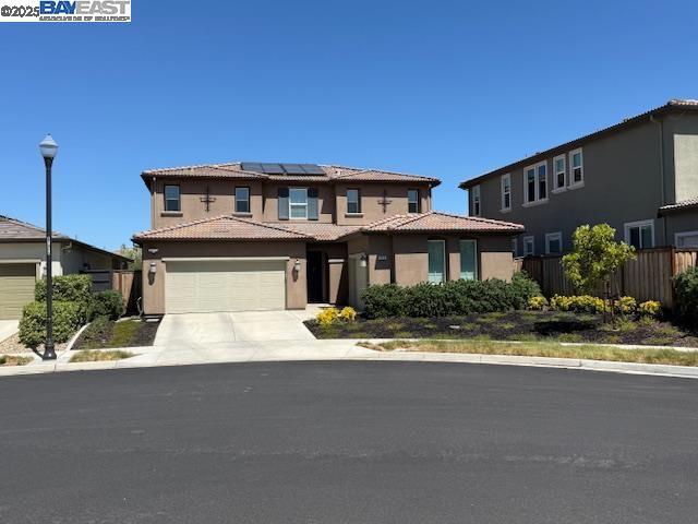 Ideal for large or multi-generational living, this 5 bed, 4.5 bath Shea Home in Tracy Hills offers smart space and comfort for everyone. Located on a quiet court near the pool, Corral Hollow school (K–8), dog park, and ACE/I-580 access. Features include a full downstairs ensuite, Jack & Jill bedrooms, flex/media room, and expansive great room. Spacious kitchen with GE Monogram appliances, quartz counters, dual ovens, 6-burner cooktop, wine fridge, and huge walk-in pantry. Owned solar with backup battery, EV charger hook-up, water softener, RO system, and whole-house fans ensure efficient, modern living. Tech upgrades include Alexa/Google/Apple compatibility, Cat5/6 wiring, smart lighting, locks, garage doors, and security, fire suppression system and more! . Low-maintenance yard with turf, BBQ gas line, and shaded patio. Epoxy garage floors and abundant storage throughout. Perfect blend of size, smart features, and multi-gen functionality—move-in ready for your whole crew.