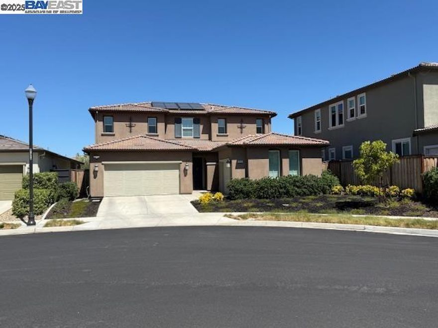 This exceptional SHEA-built home offers unmatched value in Tracy Hills with over $180K in premium builder upgrades, smart tech, and energy-efficient features. Ideally located on a quiet court walking distance to the new Corral Hollow K8 school, community pool and parks. Enjoy 5 bedrooms--one ensuite downstairs, 4.5 baths, versatile flex room, and 3-car garage. (Be sure to check out the Floor Plan.) The kitchen showcases GE Monogram appliances, quartz counters, a 6-burner range, dual ovens, and a walk-in pantry. West-facing front door--making backyard shady! Owned 16-panel solar system is paired with a 20kWh storage battery for whole-house backup and instant switch-over during outages. Smart app control for HVAC, lighting, Hunter Douglas Powerview shades, video security and more. Whole-house water softener, RO in kitchen. Dual-zone HVAC,  whole house fan, and upgraded insulation ensure year-around comfort. Low-maintenance backyard features quality turf, mandarin orange tree, rubber mulch, and a California Room patio with natural gas hookup. EV charging, upgraded flooring, custom cabinetry, epoxy garage floors, and thoughtful tech throughout. Near I-580 and ACE train. With top-tier Shea construction, location, and upgrades, this home stands out as the smartest buy in Tracy Hills.