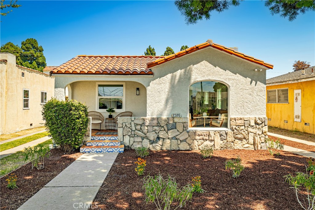 Welcome to 2320 Easy Avenue, a beautifully restored 2-bedroom, 1-bath Spanish Revival home located on a charming, tree-lined street in Long Beach. A dramatic arched front window sets the tone, showcasing the home’s classic architecture and filling the living space with warm natural light.
Originally built in 1929, this residence has been thoughtfully remodeled from top to bottom while preserving its timeless character. Step inside to find smooth-finish walls, new laminate flooring, recessed lighting, and gold-accented cabinet pulls and door handles that add a touch of elegance throughout. The completely updated kitchen features white shaker cabinetry, striking waterfall quartzite countertops, and stainless steel appliances, perfect for both everyday living and entertaining.
Sitting on a generous 5,100 sq ft street-to-alley lot, the home offers space, privacy, and potential for a future ADU or creative outdoor living. Behind the walls, it has been fully upgraded with a brand-new electrical panel, complete rewiring (including the removal of knob and tube), new drain lines, hardwired smoke and carbon monoxide detectors, and efficient mini-split systems in each bedroom and the great room.
This turnkey gem delivers all the charm of a historic Spanish home with the convenience of modern living.