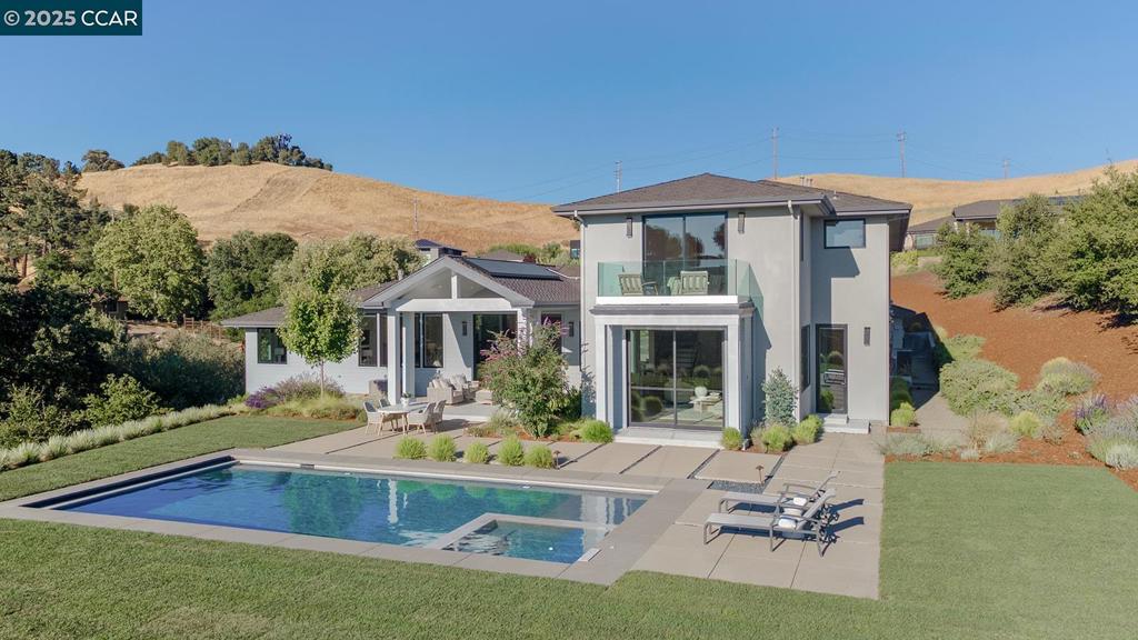 Nestled amidst golden rolling hills, we proudly present one of Diamond Construction's first homes built in Lucas Ranch, an exclusive enclave of eight custom homes surrounded by a 52-acre nature preserve. Renowned for meticulous attention to detail, this home exemplifies craftsmanship reminiscent of a bygone era, with a promise of 1/32" precision. With a combination of the highest build quality available, functional biophilic design by renowned Architect Ward Young, & planned for long term sustainability it delivers an ethereal experience within its natural surroundings. This modern traditional home embodies the essence of inspired living. European country oak flooring, full-height windows & terrestrial material selections by LMK Interiors reflect & engage natural light patterns throughout the day. Entertainer's Chef kitchen features a dual kitchen, with a spacious island dressed in Quartz Cambria Ironbridge matte counters. Two primary en-suites. One is located downstairs for additional privacy. Spacious bonus area upstairs with a loft-style design. Sliding panels in the great room glide with ease so you can entertain & enjoy the elevated indoor-outdoor lifestyle. Here,you wholeheartedly embrace the beauty of privacy and the exclusivity that comes with living in Lucas Ranch.