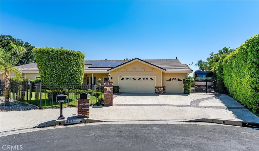 Sprawling single story upgraded estate privately situated at the very end of a quiet cul-de-sac of only 5 homes in one of the most desirable neighborhoods in Chatsworth. Located on an impressive 18,000+ SF flat lot, the property features superb curb appeal with nicely landscaped front yard, 3-car garage with large finished attic and built-in storage, & additional extra wide gated driveway perfect for RV/boat/extra parking for large gatherings. A covered front porch greets you before stepping inside the double door entry. The grand foyer opens to both a formal living room with vaulted ceiling as well as a separate formal dining room with tray ceiling, open shelves, & real hardwood flooring found throughout. The stunning completely remodeled open kitchen boasts gorgeous quartzite stone counters, center island with breakfast bar seating, stainless Cafe appliances including double ovens & 6-burner stove with pot filler, & walk-in pantry with built-in storage & pullouts. The kitchen opens to a separate family room with soaring wood beamed vaulted ceiling & stone fireplace. An additional sunlit bonus room located off the family room features wall-to-wall picture windows, two sets of glass sliders that open to the yard, & wood beamed vaulted ceiling. There are 5 spacious bedrooms including the primary suite featuring high vaulted ceiling, walk-in closet with additional wardrobe closet, & private en-suite upgraded bathroom with dual sinks, quartz counters, bath tub, walk-in shower, & separate toilet room. Two of the secondary bedrooms are massive suites, each with walk-in closets that share an oversized bathroom with dual vanities, tub, shower & built-in linen storage. The 4th bedroom has an en-suite bathroom with dual sinks, tub & shower. The 5th bedroom is located on its own wing of the house ideal for guests with access to its own upgraded bathroom. Additional living spaces include craft room/office, laundry room, & guest powder bathroom. The incredible park-like backyard is an entertainer’s dream featuring large grass lawns with walking path, covered patio with built-in heaters & fan, BBQ center with two grills & sink, above ground spa, & numerous fruit trees including grapefruit, Meyer lemon, blood orange, & plum to name a few. Huge energy savings with completely paid for solar panels. Located adjacent to horse trails, hiking, parks, dining/shopping at the Westfield Mall/Village, & easy access to the 118 freeway. Don’t miss this spectacular offering!