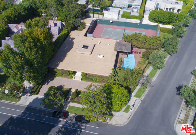 First time on the market in over 50 years this rare single story family home sits on over half acre corner property. Within a block of the Beverly Hills Hotel this five bedroom home has a championship north/south tennis court. Built in 1963 the home features terrazzo floors and fireplace opening to both the living room and den with glass doors leading to pool area. Formal dining room seats 12 Large master suite. Original kitchen and bathrooms. Separate 3 car garage. Bring your architect to remodel or visions to build on a unique extra large property in the flats.