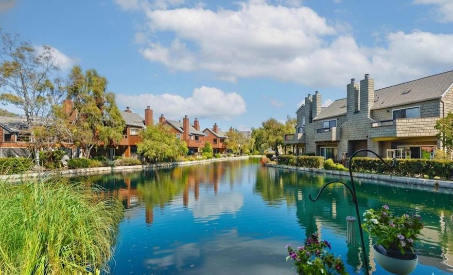 Exquisite waterfront loft in Harbortown offers the perfect blend of luxury, serenity, and convenience. Enjoy sweeping lagoon views from the living room, dining area, kitchen, and open loft above. The soaring vaulted ceilings and skylights fill the home with natural light, creating an airy, peaceful retreat. The gourmet kitchen features granite countertops and premium cabinetry. The spacious primary suite includes a private balcony with fountain view, walk-in closet, and spa-like bath with soaking tub. The versatile loft area is ideal for a home office, gym, or guest room. In-unit washer/dryer. Resort-style amenities include indoor/outdoor pools, spa, sauna, and tennis courts. Easy access to Hwy 101, shops, and top-rated Aragon High.