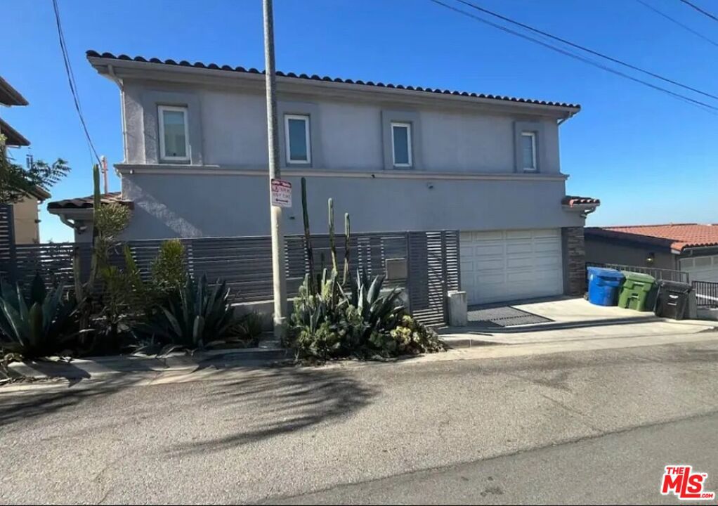 Beautiful hillside, contemporary home in Lincoln Heights with 270 Degree views from Dodger Stadium to East L.A., including Downtown L.A. skyline, Hollywood sign, and Griffith Observatory. The view extends down to Long Beach. This home comes fully furnished and includes an EV charging station. This tri-level home has its a balcony/deck on each level with exterior stairs connecting all three levels adding several hundred square feet of outdoor living space. The top floor includes two master suites with laundry between them and a wrap around balcony. The middle floor (ground floor/entry level) includes the kitchen, dining and living area, half bath, balcony and garage access. The lower level includes the third bedroom with private bathroom and living area with L-shaped couch and 70 inch flat screen TV. The balcony from the lower level allows access to the back yard, an oasis of tranquility and greenery. Subject to additional deposit for pets and furniture. No smoking inside the home. The EV charging station in located in the garage.