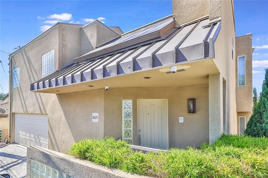 This stunning Studio City entertainer’s residence offers some of the most breathtaking panoramic views in the area. Guests are welcomed through an elevated foyer that overlooks a formal dining room and opens into a light-filled living room featuring clerestory windows.
The chef’s kitchen is thoughtfully appointed with granite countertops, a generous breakfast bar, a six-burner range, built-in wine storage, and stainless steel appliances, including a newer refrigerator.
Upstairs, the expansive primary suite is a true retreat, showcasing serene treetop views from its private balcony, a cozy fireplace, an oversized walk-in closet, and a spa-inspired bath complete with a step-up soaking tub, large skylight, glass-enclosed corner shower, and dual vanity.
An oversized guest suite with its own balcony and en-suite bath serves beautifully as a second primary or in-law suite, while two additional bedrooms provide comfortable accommodations for family or guests. The tri-level floor plan includes a separate side entrance to one bedroom with an adjacent three-quarter bath—ideal for older teenagers, long-term guests, or a private executive home office.
Additional features include a dedicated laundry room, ample storage, and an attached two-car garage. Ideally located near Studio City’s premier dining, shopping, entertainment, and major Hollywood studios, this exceptional home offers both privacy and convenience in one of the area’s most desirable neighborhoods.