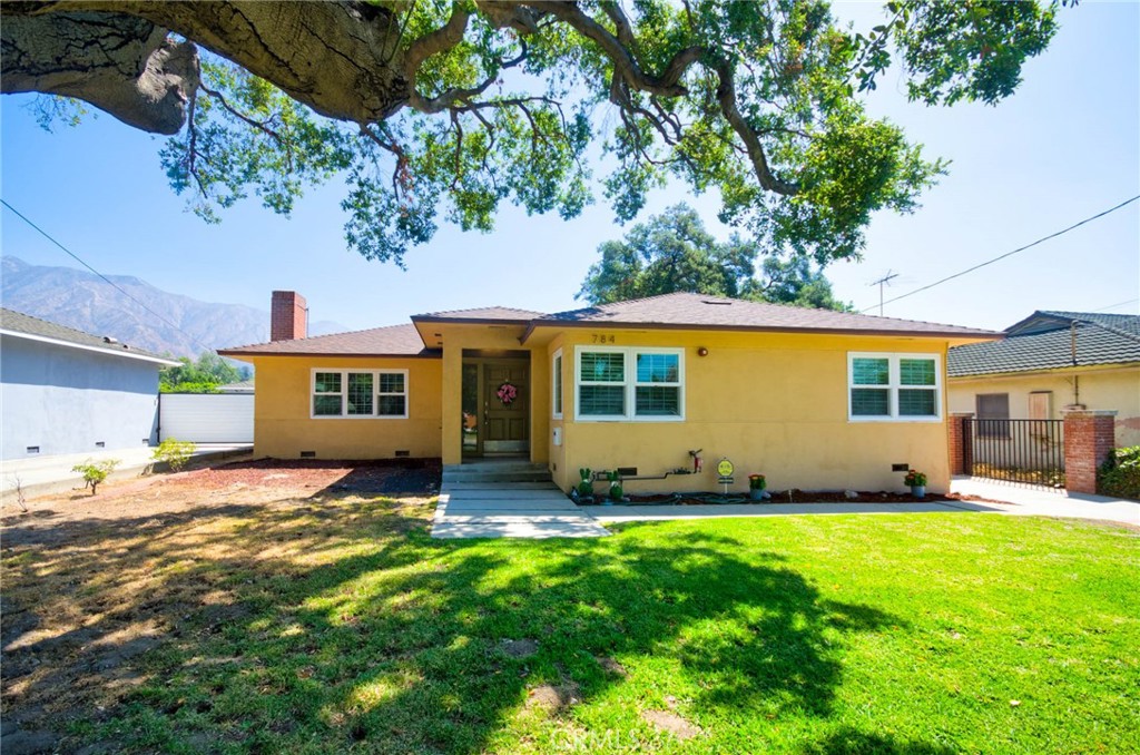784 Eaton Drive in Pasadena is a beautifully remodeled and expanded single-story 5-bedroom, 3-bathroom home in the sought-after Daisy Villa neighborhood. Originally built in 1947, a major 2015 addition and full renovation expanded the home to approximately 2,802?sq?ft on a generous 12,223?sq?ft lot. Upgrades include paid-off solar panels, dual-pane vinyl windows, and wood flooring throughout. A welcoming foyer opens to a bright living room with a cozy fireplace, while the chef’s kitchen features granite countertops, stainless steel appliances, a breakfast bar, custom cabinetry, and a charming garden window. The front wing offers a junior en suite, two additional bedrooms, and a full bath. The addition includes a spacious family room with a large bifold glass door opening to the backyard, a fourth bedroom, and the primary suite—complete with ample closet space and an updated bath. All bathrooms are tastefully renovated. A gated driveway leads to a detached 3-car garage, with an ADU design concept plan for a future unit—ideal as an in-law suite, guest quarters, or rental income. Conveniently close to the 210 Freeway, Whole Foods, Trader Joe’s, The Home Depot, Amazon Fresh, Target, Sunnyslope Park, and Gwinn Park. The backyard offers a serene setting for entertaining, gardening, or relaxing with beautiful mountain views.