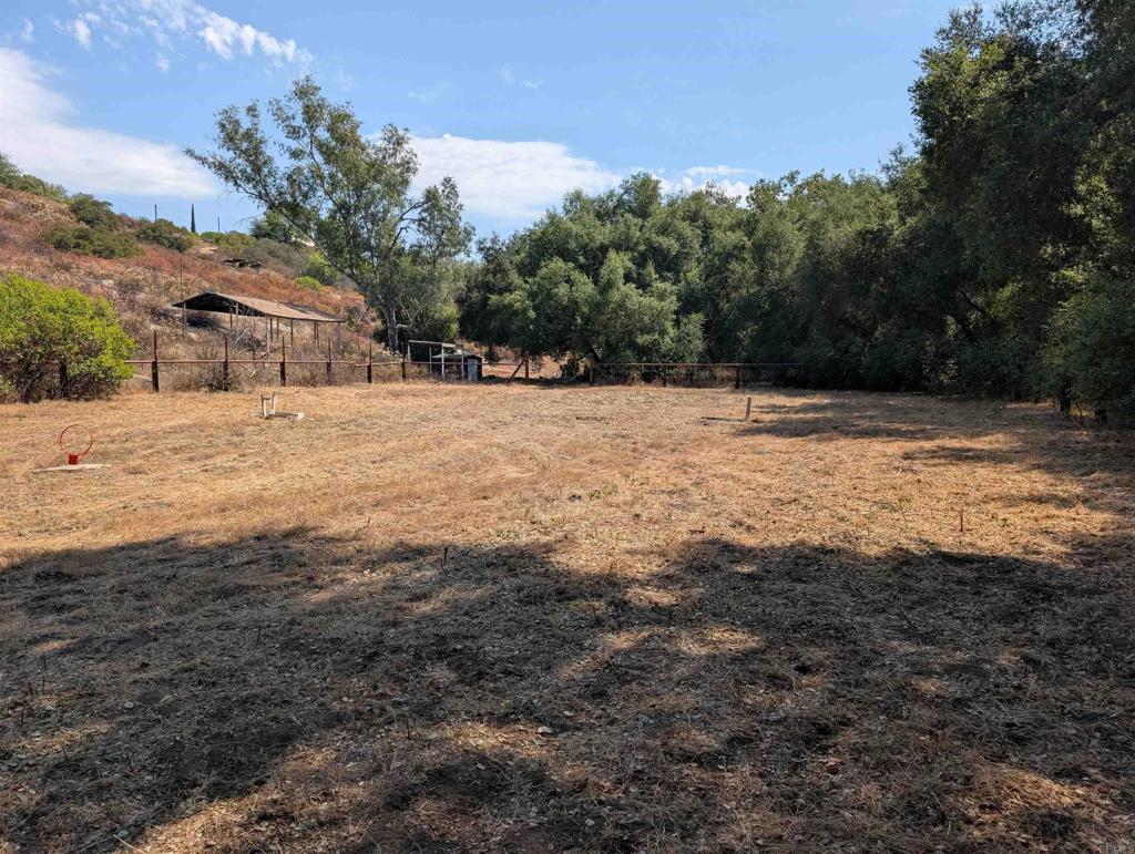 Experience privacy, natural beauty, and ready-to-enjoy amenities on this versatile 10+ acre property along Paradise Mountain Road in Valley Center. Nestled in a peaceful setting, the land offers a spacious graded pad on the upper portion—perfect for building your dream home—while the lower level features a fenced pasture with access to a seasonal creek, creating an ideal environment for horses or other livestock. Essential infrastructure is already in place, including a private water well, installed water meter, SDGE electric transformer on site, and a nearby fire hydrant for peace of mind. Prior septic approval further streamlines the path to building your dream home. Enjoy the opportunity to begin living on the land right away with a Winnebago trailer equipped with a solar array and batteries—perfect for an off-grid lifestyle while you plan your future build. The seasonal creek adds charm and character, enhancing the natural landscape. This property offers a rare chance to own a versatile piece of land in Valley Center with both convenience and seclusion. Whether you’re seeking a peaceful retreat, agricultural use, or a site for your custom estate, this land is ready to make your vision a reality.