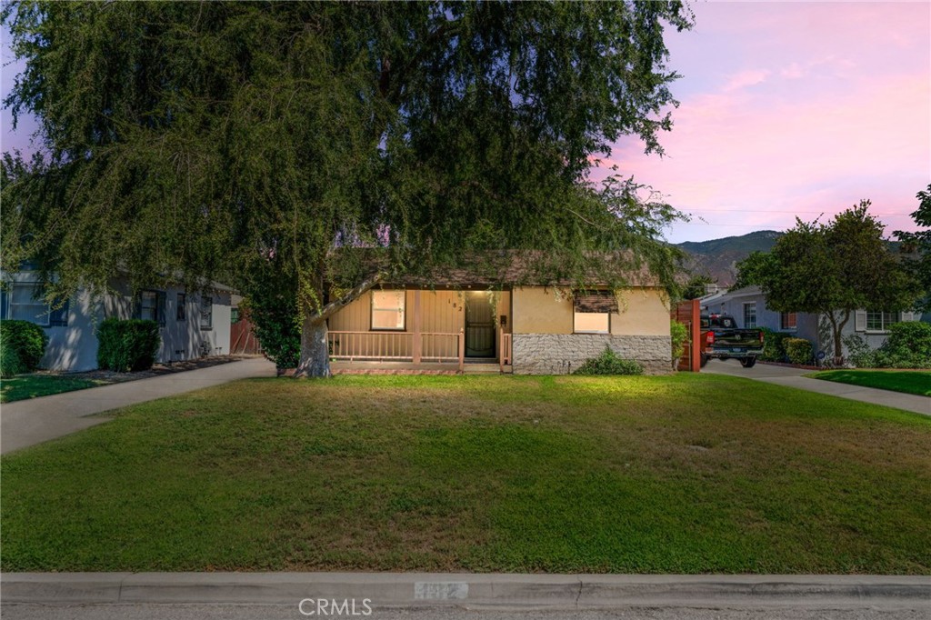 Charming post war home on a quiet, tree lined street with a sizable yard, detached two car garage, and carport - minutes from Starbucks and Stater Bros! Located in the Arrowhead neighborhood, just West of Arrowhead Country Club, this single story two bedroom home features a great layout. Enter past the front porch and into the living room - new paint and new carpets throughout. There is a dining area just off the kitchen with solid surface countertops. Bedrooms are opposite, and serviced by a full bathroom with vintage charm. There is indoor laundry, and a spacious family room off of the back with a fireplace. The large yard is fenced, and has great potential for an ADU in the back. There are mountain views as well. The water heater is brand new, and the windows were upgraded to dual pane vinyl.