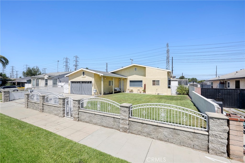 Welcome to 269 E 69th Way in Long Beach, a charming single-family residence. This 3-bedroom, 2-bath home spans 1,713 sq. ft. and sits on a spacious lot with a beautifully landscaped front yard, complete with lush green grass and a welcoming swing by the front door.
Originally built in 1949, the home has been thoughtfully updated with a new roof and upgraded plumbing. The gated property provides privacy and security, while the enclosed side yard offers the perfect spot to barbecue or relax in the shade. Inside, the generous floor plan provides comfortable living with room to grow, and the roof added in 2005 with a 40-year-warranty also allows for additional attic space.
This inviting home combines classic charm with modern upgrades, making it a wonderful opportunity to own in Long Beach.