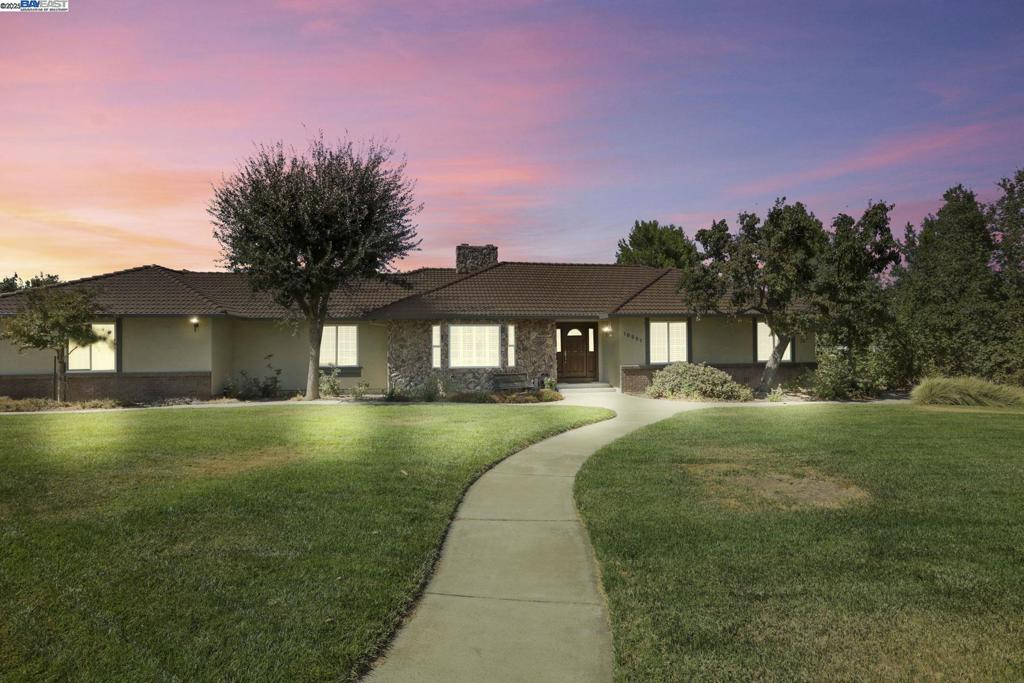 Welcome to Los Ranchos Estates! This beautifully maintained 5-bedroom, 4-bath, 3,346 sq ft ranch-style home sits on a full acre and offers exceptional space, comfort, and versatility. The property includes a 1-bedroom, 1-bath ADU with a full kitchen, porcelain tile flooring, walk-in closet, and a private entrance — perfect for multigenerational living or rental income. Enjoy cost-saving owned solar, 50-amp EV port, and 3 HVAC systems for year-round efficiency. Inside, you’ll find gorgeous hardwood floors, soaring ceilings, dual-pane Milgard windows, new water softener, and new central vacuum system. The spacious 3-car garage features a durable polyaspartic floor coating, while the newer fencing enhances privacy and security. Step outside to a vegetable garden, automatic sprinklers, drip irrigation throughout, chicken coop, and wide-open space with room to roam. Located just off Mountain House Pkwy, this home offers quick access to freeways, shopping, and everyday conveniences — yet still feels tucked away in a peaceful, tight-knit neighborhood. Close to Lammersville K-8 and Mountain House High School. Enjoy holiday parades, horseback riders, and a true sense of community — a rare lifestyle that’s hard to find and easy to fall in love with.