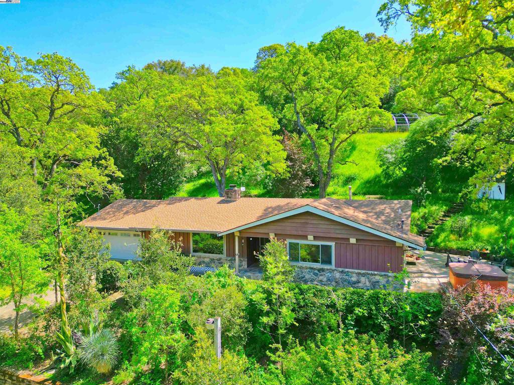 Newly priced! Lovely, private country home on nearly 5 oak-studded acres with gorgeous Mt Diablo views, 10 minutes to shopping & Clayton schools. Set back from the road, with a gated driveway and wonderful, huge 1200+ sf shop with room for workshop, tractor or vehicle storage, more. Relax on the expansive deck under the oak trees, with spa & incredible views. The spacious living room features hardwood flooring and a wood stove. The family chef will enjoy the large kitchen with gas range, stainless appliances, breakfast bar, tiled counters & backsplash; adjacent dining area with hardwood flooring. Andersen windows, ceiling fans & whole house fan provide for your comfort. Convenient municipal water. A warm and cozy home, move-in ready!