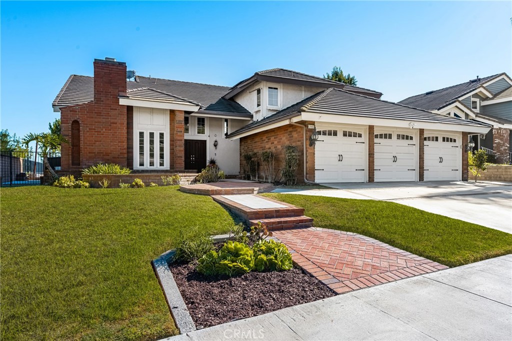 Nestled in a quiet neighborhood, this home is located within the pick of award-winning schools, with nearby sports facilities and parks. Conveniently close to shopping, dining, and freeway access. An ideal blend of comfort, convenience, and community.
This stunning 5 bed, 3 bath home features vaulted ceilings and brand new carpet. Expansive living spaces with fireplaces, large windows and a first floor bedroom and full bathroom.
Gourmet kitchen with granite counters, upgraded cabinetry, breakfast nook, crown molding, desk area, and glass-front cabinets. Oversized master suite with soaring ceilings, extensive closet space, tub, separate shower, and skylight. Additional bedrooms are generously sized with mirrored closet doors. Inside laundry room, alarm system, and LED lighting throughout.
Entertainer’s backyard with pool and spa, covered patio, and extensive brickwork.