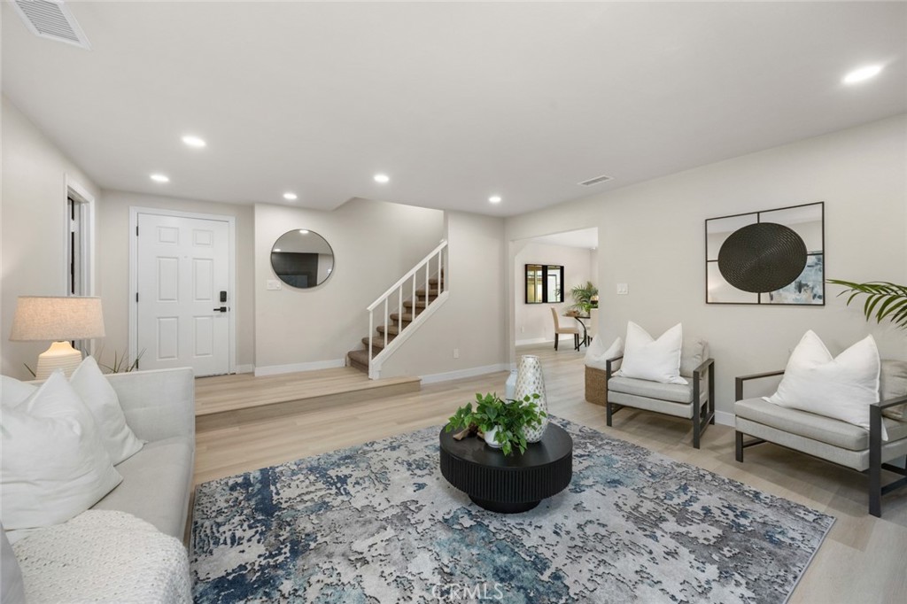 This completely remodeled, modern style, ultra-versatile home is wonderful for a family..... 3 Bedrooms and 2 Bathrooms on the first floor and 2 Bedrooms and one Bathroom on the second floor, perfect for growing families and multigenerational living! This spacious 5-bedroom, 3-bathroom home blends comfort, style, and functionality like no other! Fresh upgrades throughout: new laminate flooring throughout, and freshly painted interior. A sleek, new gourmet, modern kitchen featuring custom cabinetry, designer Quartz countertops, stainless steel 5-burner gas range, and matching dishwasher. New interior and exterior doors, new HVAC A/C system and newer double pane windows. New bathrooms with modern vanities and quartz counter tops. New landscaping with sprinklers in both front and back yard. It's a must see! This home is hardly a mile away from the 91 freeway and situated close to 605 and 5 freeways! La Palma City is conveniently located right on the border of Los Angeles and Orange counties!