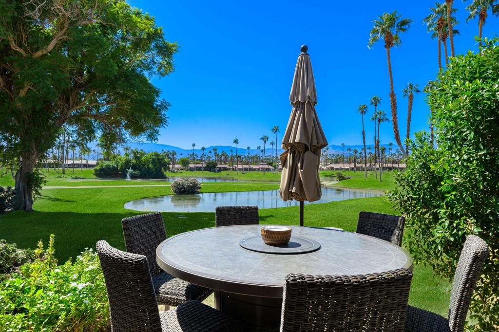 LOCATION, LUXURY, & LIFESTYLE!Stunning End-Unit Condo with Panoramic Mountain, Water & Golf Course ViewsSituated in a prime location with breathtaking southern panoramic views, this beautifully remodeled 3-bedroom, 2-bath end-unit condo (1,627 sq. ft.) overlooks serene lakes, the prestigious Championship Course Holes # 11, 12, & 13, and the iconic Palm Valley ''Signature Island Green.''Step inside to a modern, open-concept layout designed for seamless indoor-outdoor living and effortless entertaining. The upgraded chef's kitchen boasts custom cabinetry, quartz countertops, and top-of-the-line stainless steel appliances. Both bathrooms feature sleek, tiled walk-in showers and bidets, blending comfort with modern elegance.Other highlights include:Furnished per inventory - move-in ready or rental-readyInsulated garage with built-in cabinets for added storageExtended pavered driveway - rare, extra-long lot perfect for guest parkingPrivate golf course patio with unforgettable sunset and water viewsMature Argentine Mesquite tree offers natural shade & added privacyPie-shaped lot spacing - generous separation from neighborsEnjoy resort-style amenities in this vibrant community that allows short-term rentals, making it ideal as a full-time residence, vacation retreat, or income-generating investment. The Club offers a wide range of activities, social events, and fitness/lifestyle amenities to suit every interest.Don't miss this rare opportunity to own one of the best view locations in Palm Valley--perfect for year-round living or a stylish desert getaway!