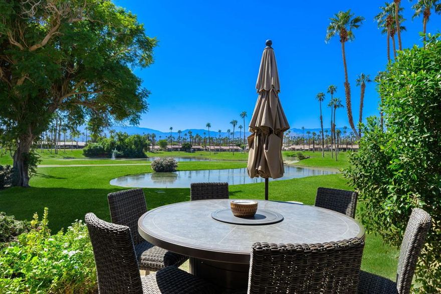 LOCATION, LUXURY, & LIFESTYLE!Stunning End-Unit Condo with Panoramic Mountain, Water & Golf Course ViewsSituated in a prime location with breathtaking southern panoramic views, this beautifully remodeled 3-bedroom, 2-bath end-unit condo (1,627 sq. ft.) overlooks serene lakes, the prestigious Championship Course Holes # 11, 12, & 13, and the iconic Palm Valley ''Signature Island Green.''Step inside to a modern, open-concept layout designed for seamless indoor-outdoor living and effortless entertaining. The upgraded chef's kitchen boasts custom cabinetry, quartz countertops, and top-of-the-line stainless steel appliances. Both bathrooms feature sleek, tiled walk-in showers and bidets, blending comfort with modern elegance.Other highlights include:Furnished per inventory - move-in ready or rental-readyInsulated garage with built-in cabinets for added storageExtended pavered driveway - rare, extra-long lot perfect for guest parkingPrivate golf course patio with unforgettable sunset and water viewsMature Argentine Mesquite tree offers natural shade & added privacyPie-shaped lot spacing - generous separation from neighborsEnjoy resort-style amenities in this vibrant community that allows short-term rentals, making it ideal as a full-time residence, vacation retreat, or income-generating investment. The Club offers a wide range of activities, social events, and fitness/lifestyle amenities to suit every interest.Don't miss this rare opportunity to own one of the best view locations in Palm Valley--perfect for year-round living or a stylish desert getaway!