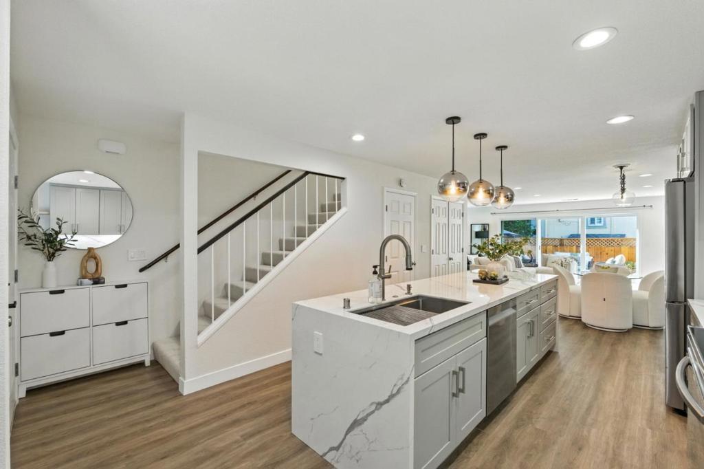 Tired of trade-offs? This townhome gives you everything: style, space, parking, and the private outdoor retreat you've been hoping for. Just steps from downtown, this remodeled home delivers. The open concept kitchen features a large island and abundant storage, perfect for cooking, gathering, and entertaining. Indoor-outdoor living comes easy with a patio, deck, and garden space. Upstairs, two bedrooms each offer en suite baths and generous closets, including a super spacious primary suite. Extras include side-by-side laundry, two parking spaces (garage + carport), and a welcoming four-home community with low monthly fees.