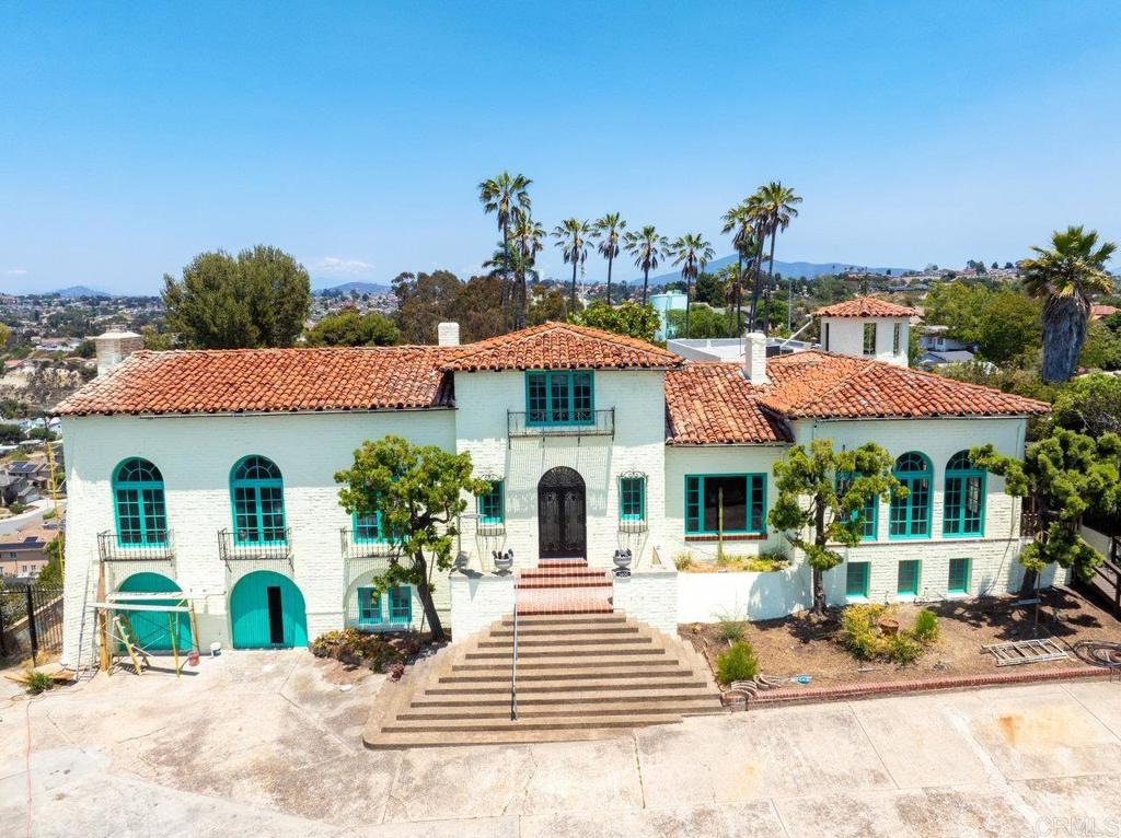 The Collins-Wellington Estate | Spanish-Revival Masterpiece on 8 Private Acres – Mills Act Designated Step into timeless grandeur at the Collins-Wellington Estate, a one-of-a-kind Spanish-Revival castle nestled atop 8 secluded acres in the heart of San Diego. This historic 1928 architectural marvel was envisioned by H.A. Collins and later cherished by the prestigious Wellington family—famed for hosting soirées attended by Southern California’s elite. A gated, tree-lined drive welcomes you with a quarter-mile of privacy and anticipation, leading to a majestic 5,766 sq ft residence rich in heritage and soul. Listed on the Historic Register and benefitting from significant tax savings under the Mills Act, this estate is truly a legacy property. Inside, every corner tells a story—original peg-and-bowtie curly oak floors, hand-painted ceiling designs, inlaid onyx flooring, and soaring 18-foot cathedral ceilings blend seamlessly with the intricate wrought iron and arched motifs that define authentic Spanish architecture. Enter through a regal double-height stone foyer with gilded detailing and a stunning wrought-iron staircase lined with hand-painted Spanish tiles. The 35’ x 25’ grand ballroom—once alive with the sounds of live musicians serenading from the balcony above—is a crown jewel of old-world glamour. The estate offers four expansive bedrooms, each with en-suite baths and space for additional sitting areas or home offices. A charming upstairs loft overlooks the ballroom and can function beautifully as a study or fifth bedroom. Highlights Include: - Iconic 1928 Spanish-Revival architecture - 8 acres of gated, private land - 5,766 sq ft of luxurious living space - Grand ballroom with cathedral ceiling & balcony - Historic designation with Mills Act tax benefits - Curly oak floors, inlaid onyx, artisan tilework, and hand-painted ceilings - Architectural details rarely found in modern construction - Ideal for entertainers, history lovers, or legacy homeowners Rarely does such a majestic estate become available. Whether you're seeking a luxurious private retreat, a showstopping entertainer’s dream, or a historical masterpiece to steward into the future—The Collins-Wellington Estate is a once-in-a-lifetime offering. Arrange your private tour of this extraordinary castle in San Diego.