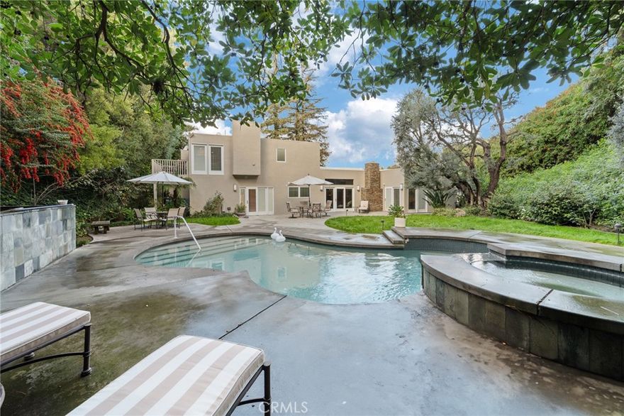 Welcome to your private retreat estate in the prestigious Encino Hills, peacefully tucked south of Ventura Boulevard at the top of a quiet cul-de-sac. 6 bedrooms, 5 en-suite, 5.5 total baths, Formal Living, Family and  Dining rooms. Breakfast Area, utility room, butlers pantry, 3 fireplaces, private elevator, Pool, Spa, 3 zoned AC…nearly 5000 Sq.ft on 15,000 ft lot!! Originally built in 1965 and reimagined with a major expansion in 2004 blends luxury, warmth, and timeless design with many 15 ft. ceilings and skylights. Oversized two-car garage with storage capacity rarely found in residential homes. Chefs kitchen w/ designer hardware, dual refrigerators, dual ovens, and premium Sub-Zero and Thermador appliances. Thoughtful details appear throughout—Venetian plaster, built-in glass curio. Sitting well above the street, it enjoys exceptional serenity and complete privacy. A dramatic 50-foot waterfall feature creates a true five-star resort entrance. The primary suite, accessible by private elevator or stairs, is an oasis of its own with dual walk-in closets, a spa-inspired bathroom, and a peaceful private balcony overlooking the surrounding trees. The backyard feels like a mountain escape, surrounded by mature pine, elm, and oak trees. Enjoy a large swimming pool with attached spa, multiple areas for lounging and outdoor dining, and complete seclusion from the outside world. 3601 Cananea Drive is more than a home — it’s a sanctuary. A rare blend of luxury, privacy, and resort-style living high above the city.