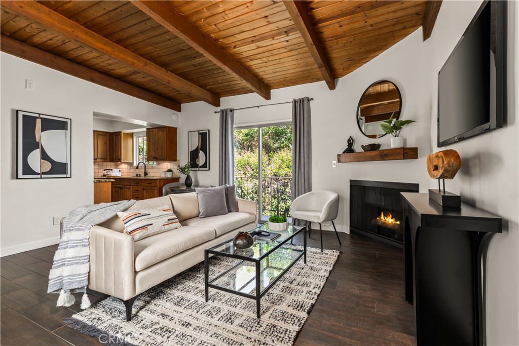As you enter the unit, you're immediately welcomed by an open-concept living and dining area, warmed by a charming fireplace in the living room. Come home to relax in a space featuring wood-like floors and beam-accented ceilings. Step onto the adorable balcony—perfect for letting in a refreshing cross breeze.The beautiful kitchen boasts stone countertops, a terracotta tile backsplash, an over-the-range microwave, and generous counter space on either side of the stove—an ideal setup to flex your culinary muscles for family and friends.As you move past the kitchen, you'll find an ample linen closet and a laundry closet with space for a side-by-side washer and dryer. To your right, just before the bedroom, is a grand bathroom featuring a stone countertop vanity with abundant counter space and an exquisite tile-walled shower-tub combo.At the end of the hallway, the spacious bedroom awaits, complete with a large closet. All of this, plus access to a pool and located just a few blocks from Ventura Blvd and everything it has to offer.
