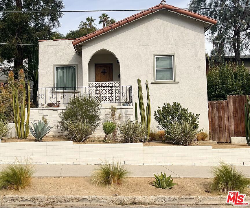 An opportunity to call this charming 1925 Spanish, home. Located on a quiet Eagle Rock street yet close to it all, this sweet house is flooded with natural light. The open living room flows seamlessly into the kitchen, dining area, and patio, perfect for entertaining or al fresco meals. Both bedrooms are bright and airy, separated by a full bath for privacy. Outdoors, enjoy a beautifully landscaped mix of drought-tolerant succulents, garden beds, and different sitting areas. A long driveway provides ample parking, leaving the garage free to use as a creative studio or office. All this in an unbeatable location just blocks from Colorado Blvd., Trader Joe's, and the best of York & Figueroa.