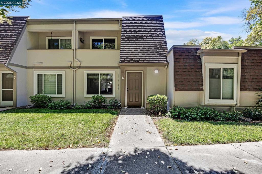 Welcome to 1544 Schenone Court, Unit B, an impeccably updated townhouse nestled in the highly desirable Diablo Creek community. This move-in ready home features two bedrooms, one and one-half bathrooms, and roughly 1,090 square feet of space. The beautifully updated kitchen showcases custom cabinets, granite counters, and stainless steel appliances, flowing effortlessly into an oversized dining area, nice for entertaining. Wood flooring runs throughout, and the spacious living room offers a refaced fireplace that creates a warm and inviting atmosphere. Upstairs, enjoy two oversized bright bedrooms, one with a walk-in closet and the other with a private balcony, along with a stunningly updated full bathroom. Additional highlights include dual pane windows, a skylight for added natural light, inside laundry with washer and dryer included, and two assigned parking spots, one covered and one uncovered with direct access behind the backyard gate. Relax or entertain in your lovely private patio area. Located just steps from the Clayton Valley Shopping Center with restaurants, Starbucks, groceries, and more, this home combines comfort, convenience and modern style in one exceptional package.