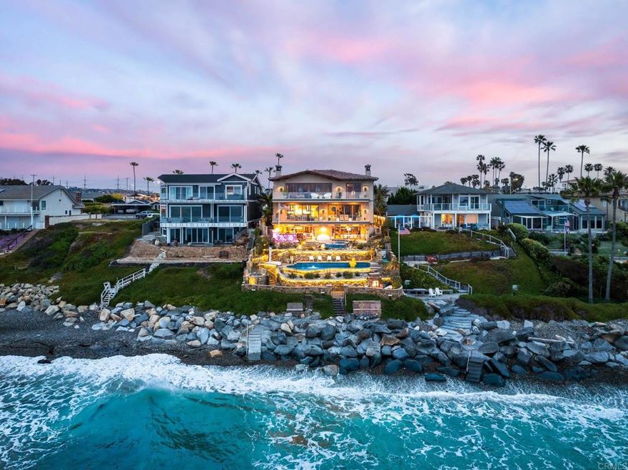 Experience unparalleled coastal luxury with this extraordinary beachfront estate, offering private beach access in the prestigious Tierra del Oro enclave of Carlsbad. Here, the rhythmic sound of white-water waves and vibrant sunsets over the Pacific are not just scenic moments—they're your everyday backdrop.Set on a rare, private 1/3-acre lot with 63 feet of direct ocean frontage, a pool overlooking the ocean (rare find and may not be able to be built again), this custom European-inspired masterpiece combines timeless craftsmanship with refined modern elegance. Meticulously updated throughout, the 6,480-square-foot residence offers up to 5 spacious bedrooms, 4 full bathrooms, and a stylish powder room, all thoughtfully arranged within a flowing open-concept design that seamlessly connects formal and informal living spaces.Every inch of this home has been curated with unmatched attention to detail—featuring rare, hand-selected stones and hardwoods, artisan-crafted finishes, and custom solid wood millwork. Designer lighting and fixtures elevate the ambiance, while a lighted custom staircase connects all three levels of the home, adding a dramatic architectural focal point.Retractable glass doors on every level blur the line between indoors and out, revealing panoramic ocean views stretching from La Jolla to Dana Point and inviting in the sea breeze. The result is a truly seamless indoor-outdoor living experience, ideal for both intimate relaxation and grand entertaining.Host with distinction with a stunning, glass-walled, temperature-controlled wine cellar paired with a sleek service bar, icemaker, and abundant storage—perfectly suited for gatherings and celebrations. Step outside to a breathtaking exterior oasis, complete with a lushly landscaped front courtyard entry, sparkling swimming pool(unique and may be hard to replicate), spa, and expansive summer kitchen with dining bar. Lounge by the fireplace or fire pit, sip cocktails as the sun sets, or dine alfresco under the stars, all while taking in uninterrupted views of the Pacific coastline. Additional exceptional features include: Steps leading to the private “wet sand beach”, Pool overlooking the ocean is a rare find and may not be able to be built again, Oversized 3-car garage, Office/library,  Lutron lighting system, Five interior gas fireplaces, Outdoor heaters and shower, LED lighting throughout, Extensive exterior lighting, Copper gutters, downspouts, and trim, Custom storage for surfboards and water toys, Generous interior storage solutions. This exquisite estate is more than a home—it’s a lifestyle of unparalleled beauty, comfort, and coastal sophistication. Experience the very best of Carlsbad luxury living.