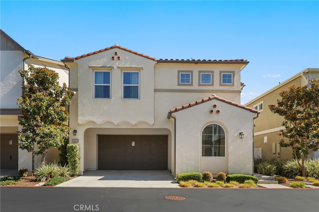 Modern Coastal Living in Aura with 4 Bedrooms, A Loft, and Minutes from the Beach. Tucked into one of the most private and desirable locations within Aura—a contemporary enclave of newer detached homes in Costa Mesa—this 4 bedroom, 3 bathroom residence built in 2017 offers 2,225 square feet of modern design, comfort, and convenience. Just minutes from the beach, Segerstrom Center for the Arts, and South Coast Plaza, it provides the ultimate Southern California lifestyle. The open-concept first floor features soaring ceilings, abundant natural light, and a seamless flow between the living, dining, and kitchen areas. The gourmet kitchen is the heart of the home, showcasing quartz countertops, soft-close shaker cabinetry, a deep farmhouse sink, a large center island with pendant lighting, and premium Bertazzoni Italian appliances. A main-floor bedroom and full bath offer flexibility for guests or a home office. Upstairs, the spacious primary suite includes dual walk-in closets and a spa-inspired bath with dual vanities, a frameless walk-in shower with multiple showerheads and bench, and a private water closet. Two additional bedrooms, a versatile loft, and a full bath provide comfort and functionality, while the upstairs laundry room with utility sink and built-in cabinetry adds convenience. Wide-plank waterproof laminate flooring, LED recessed lighting, designer fixtures, central A/C, and dual-pane windows enhance the home’s modern appeal. The private backyard features pavers, block walls, and vinyl fencing, creating a low-maintenance space perfect for entertaining. A two-car garage with full driveway parking, along with access to the community park with playground and BBQ area, round out the property. With a home warranty through 2029 and a location that blends coastal living with easy access to freeways, shopping, and entertainment, this Aura home truly checks every box.