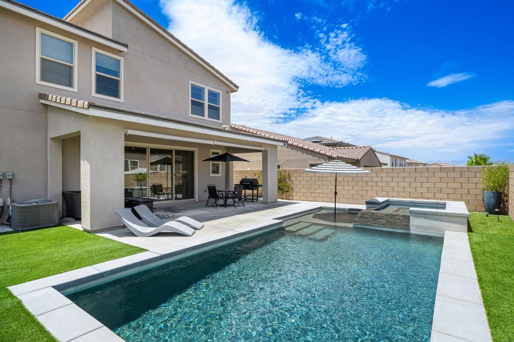 Introducing a beautifully crafted home in the heart of the vibrant University Park community in Palm Desert, where luxury meets modern living. This exquisitely upgraded residence welcomes you with Mountain View's, soaring ceilings and an abundance of natural light, providing a warm and inviting atmosphere.Step inside to discover a spacious layout featuring 4 bedrooms and 31/2 baths, ensuring ample space for both family and guests. The open-concept entertainment area is designed for effortless hosting, with the kitchen, dining, and living areas flowing seamlessly together. The gourmet kitchen boasts double ovens, a 5-burner stovetop, and luxurious upgrades like premium countertops, a stylish backsplash, and a generous pantry.Experience the harmonious indoor-outdoor lifestyle with seamless connectivity between the living spaces and a serene, private courtyard located at the home's center. The backyard is truly an entertainer's paradise, offering a large pool with a tanning deck, a rejuvenating spa, and an expansive covered patio area perfect for gatherings.Retreat to the primary suite, a true haven of relaxation, featuring a spacious walk-in closet and an opulent primary bathroom. This luxurious escape is adorned with custom details, including dual vanities, a luxurious soaking tub, and an expansive walk-in shower. Venture upstairs to find a vast loft currently serving as a media room, providing additional versatile space.Daily convenience is elevated with a dedicated laundry room offering ample storage, and enjoy significant savings on electricity with a leased solar system, making this home as efficient as it is elegant.Residing in the new University Park community comes with an array of perks, notably The Grove--a resort-inspired oasis for residents. Indulge in lavish amenities including resort-style pools, pickleball courts, a state-of-the-art fitness center, and a shaded playground. The community's social heartbeat is an event lawn complete with a stage, a cozy fire pit, and a barbecue area for memorable evenings with family and friends.Don't miss your chance to own a piece of paradise in one of Palm Desert's most sought-after communities. This home is not just a residence, but a lifestyle.