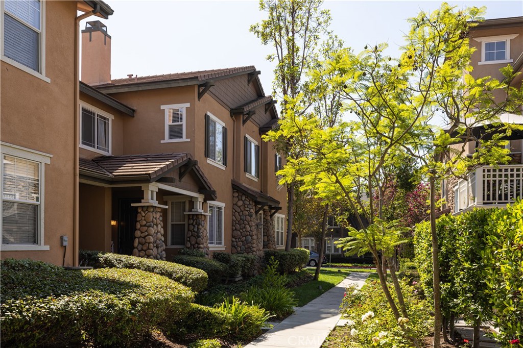 Welcome to this exquisitely upgraded Ladera townhome, perfectly situated in the highly sought-after, FHA/VA-approved community of Chambray . Step inside to a sun-drenched, open floor plan featuring beautiful wood laminate flooring, crown moldings in the family and dining rooms, and recessed lighting throughout the downstairs, with a cozy fireplace as a focal point in the family room. The gourmet, renovated kitchen is a chef's dream, boasting pristine quartz countertops, a gas range, a water filtration system, a subway tile backsplash, and matching stainless steel appliances. A convenient small office space and a half bath with tile flooring and a built-in vanity are also located on the main floor. Upstairs, you'll find laminate flooring and recessed lighting, along with all the bedrooms, including a primary suite that features dual sinks in the bathroom and a walk-in closet. The hall bath on this level also has tile flooring. This residence is equipped with central AC/Heat, dual-pane windows, a Nest system for smart climate control, and a fire sprinkler system for added safety. The attached garage is EV-ready with a charger and includes overhead storage racks for extra space. Beyond the home, you can embrace the ultimate resort-style living with Ladera Ranch's vast array of amenities, such as a waterpark, sports and skate parks, several clubhouses, tennis courts, scenic trails, a community garden, and a dog park, all situated directly across the street from a shopping center with Albertsons, a Starbucks, and dining options. The entire community has been recently re-piped, and this exceptional home is also within the attendance boundaries of highly-regarded, award-winning Chaparral Elementary and Ladera Intermediate Schools, making it the perfect place to welcome home.