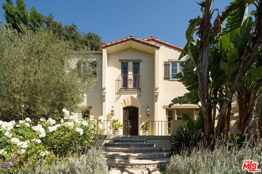 Set in the Los Feliz hills, this discreet 1925 Mediterranean estate sits on a rare, flat 16,623 sq. ft. lot, landscaped to perfection and featuring a luxury hotel-inspired pool area. Rife with incredible original details, the 5 bedroom, 6 bathroom home boasts seamless indoor/outdoor flow, with numerous french doors opening onto the property's multiple outdoor seating and entertaining spaces. Entirely gated, and surrounded by mature hedging and abundant trees, the expansive property offers utmost privacy and tranquility. Past the front iron gate, a path of rosemary and rose bushes leads to the stone front terrace. Through the original curved wood front door, find the open, light-filled home, brimming with character and classic Mediterranean touches, including ornate ironwork and stunning light fixtures throughout. Upon entering, find a formal living room to your right, with high ceilings, ornate fireplace, breathtaking curved window overlooking the verdant side yard, and french doors leading to the veranda. The first floor features a front office, formal dining room, den, kitchen, and maid's quarters with a full bathroom, each room flooded with abundant light and seamlessly connected by graceful archways. A chef's kitchen features a center island, Sub-Zero refrigerator, Viking stove, and french doors leading to an outdoor dining and lounge area with a fire pit, overlooking the side yard's many fruit trees. The second floor unveils four generously sized bedrooms and three bathrooms. The expansive primary suite offers a haven of comfort and style, featuring two Juliet balconies, carved stone fireplace, and walk-in closet. The primary bathroom is a true oasis, boasting a soaking tub that overlooks the serene Los Feliz hills, dual sinks, a water closet, and a steam shower. The outdoor space is simply outstanding: each side of the house landscaped to perfection with walking paths, two firepits, outdoor kitchen, and multiple sitting areas. The saltwater pool sits behind an iron gate behind the home - the property's centerpiece. Surrounded by mature trees, and featuring a lounge area with firepit, outdoor dining area covered by majestic trellis, and multiple lounge areas, the pool area is awe-inspiring and meant for entertaining. Sited on a corner lot just a few blocks from entry points to Griffith Park's hiking trails and tennis courts, and also walkable to Hillhurst's best bars, shops and restaurants, the location is ideal. This Mediterranean estate is not just a home; it's a piece of Los Feliz history waiting for its next chapter. Don't miss your chance to call this exceptional property your own.