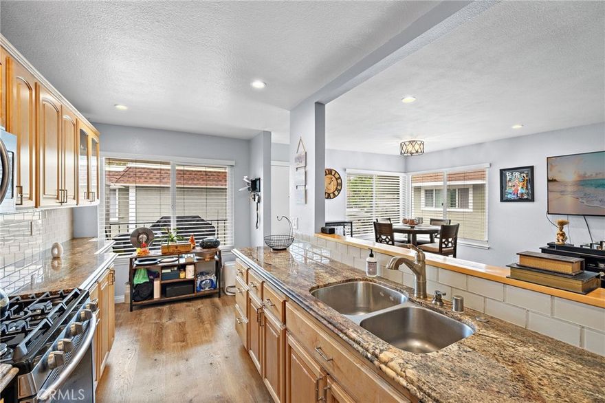 New improved price! Beautiful Upper-Level End Unit in Mission Viejo - this charming 2-bedroom, 1.25-bath condo is located in one of Mission Viejo’s most desirable communities and has LVP flooring throughout. The light-filled living area features recessed lighting and an open layout connecting seamlessly to the upgraded kitchen with granite countertops, shaker cabinets, and modern hardware. The primary suite offers a large window with a view of the mountains, private vanity, and a recently updated walk-in closet, with direct access to the shared full bath. A convenient laundry room near the kitchen fits a full-size washer/dryer with additional cabinet storage. Relax on the spacious patio, perfect for outdoor dining and entertaining. Parking includes a one-car garage with overhead storage and an additional assigned space just steps away. Community amenities include a pool, wading pool, playground, and tot lot, with nearby award-winning schools, shopping, and dining. Residents also enjoy exclusive Lake Mission Viejo membership.