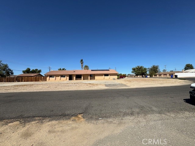 Welcome to 18080 Manitou Rd in the heart of Desert Knolls! This custom-built single-level home sits on a beautiful 0.92-acre corner lot and offers so much to love. Inside, you’ll find 3 spacious bedrooms, 2 full baths, and one half bath across 1,980 sq. ft., plus a 576 sq. ft. guest house with its own half bath, tile flooring, and sliding glass doors—perfect for guests, extended family, art room, or a private office. The main home features a large living room with a cozy wood-burning corner fireplace, an open kitchen with a generous utility/laundry room, and a primary suite with direct access to the back yard through a sliding door. Outdoors, the property shines with horse zoning and cross-fencing, a circular driveway, an attached 2-car garage with a side driveway, a covered RV carport with hookups, multiple RV gates, and two storage sheds. Enjoy evenings under the spacious covered patio or take advantage of the nearby Mojave Narrows Park—for horseback riding and outdoor fun. Other features include solar panels, stucco exterior, and a prime Desert Knolls location close to Highway 18, schools, shopping, and commuter routes. This unique property truly has something for everyone—space, comfort, and endless potential to make it your own! Call today to schedule a tour!!!