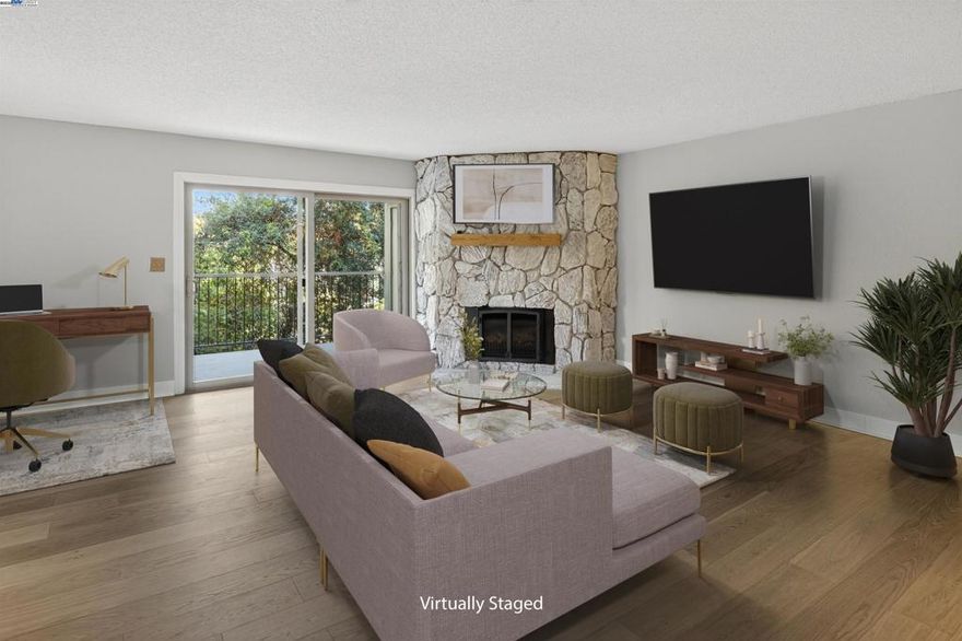 Tucked in a private setting just steps from downtown San Leandro and BART, this unit has one of the largest floor plans in the community—1,728 sq ft of comfortable, contemporary living space. Enjoy a peaceful wraparound balcony overlooking lush green space, ideal for morning coffee or evening relaxation.  The updated kitchen features shaker-style cabinets, granite countertops, a breakfast bar, and additional built-in cabinetry in the dining area. The open-concept kitchen/living/dining spaces include white oak engineered hardwood flooring, modern lighting, and a cozy gas-burning fireplace. A versatile bonus area off the living room is perfect for a home office or reading nook.  Retreat to the spacious primary suite with a remodeled spa-inspired bathroom showcasing double sinks, quartz countertops, Grohe fixtures, a rain showerhead, marble shower floor, and subway tile walls. The second bedroom features a Murphy bed and a large walk-in closet—perfect for guests or a flex space. Additional highlights include dual-pane windows, secure parking, a Nest thermostat, in-unit laundry, porcelain tile flooring in the entry and baths, and new closet doors in the primary suite.  An exceptional blend of space, privacy, and convenience—just minutes to shops, dining, and more!
