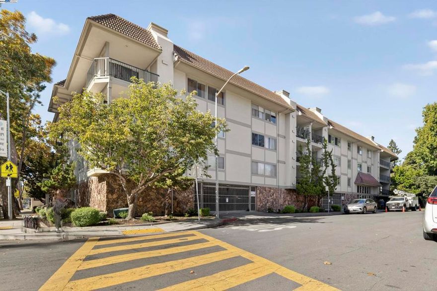 Tucked in a private setting just steps from downtown San Leandro and BART, this unit has one of the largest floor plans in the community—1,728 sq ft of comfortable, contemporary living space. Enjoy a peaceful wraparound balcony overlooking lush green space, ideal for morning coffee or evening relaxation.  The updated kitchen features shaker-style cabinets, granite countertops, a breakfast bar, and additional built-in cabinetry in the dining area. The open-concept kitchen/living/dining spaces include white oak engineered hardwood flooring, modern lighting, and a cozy gas-burning fireplace. A versatile bonus area off the living room is perfect for a home office or reading nook.  Retreat to the spacious primary suite with a remodeled spa-inspired bathroom showcasing double sinks, quartz countertops, Grohe fixtures, a rain showerhead, marble shower floor, and subway tile walls. The second bedroom features a Murphy bed and a large walk-in closet—perfect for guests or a flex space. Additional highlights include dual-pane windows, secure parking, a Nest thermostat, in-unit laundry, porcelain tile flooring in the entry and baths, and new closet doors in the primary suite.  An exceptional blend of space, privacy, and convenience—just minutes to shops, dining, and more!