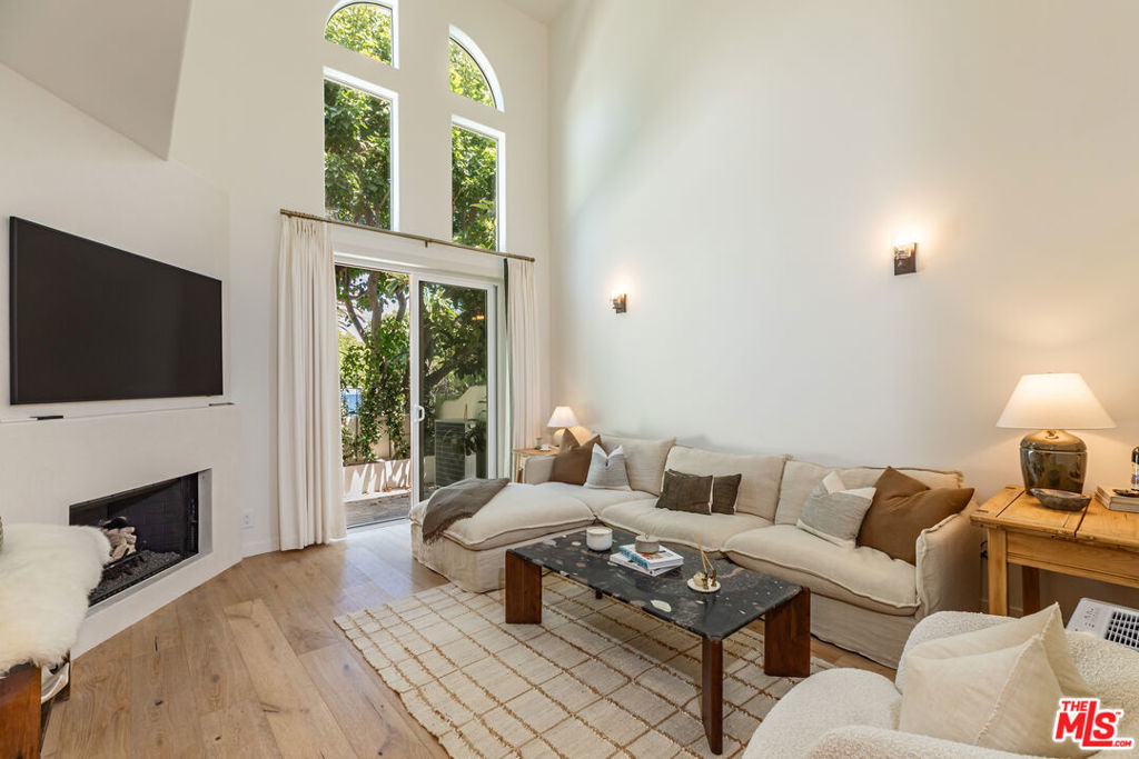 Tucked behind the gates of The Pointe at Malibu, this beautifully reimagined 2-bedroom, 2.5-bath townhome offers elevated coastal living just moments from Zuma Beach. Worthy of an Architectural Digest spread - thoughtful design and custom finishes define the space, featuring soaring ceilings, wide-plank oak floors, and arched windows that bathe the home in natural light. The chef's kitchen features quartz countertops, brass hardware, and stainless appliances, opening seamlessly into a warm and inviting dining and living area anchored by a fireplace and private patio. Each bathroom is distinct and luxurious, from the Venetian plaster bathrooms to the spa-like primary bath with soaking tub and marble finishes. The primary suite includes vaulted ceilings, a private balcony, and a custom walk-in closet. With a two-car garage, in-unit laundry, and access to resort-style amenities including a pool, spa, gym, and tennis court, this turnkey Malibu retreat pairs refined design with effortless California living.