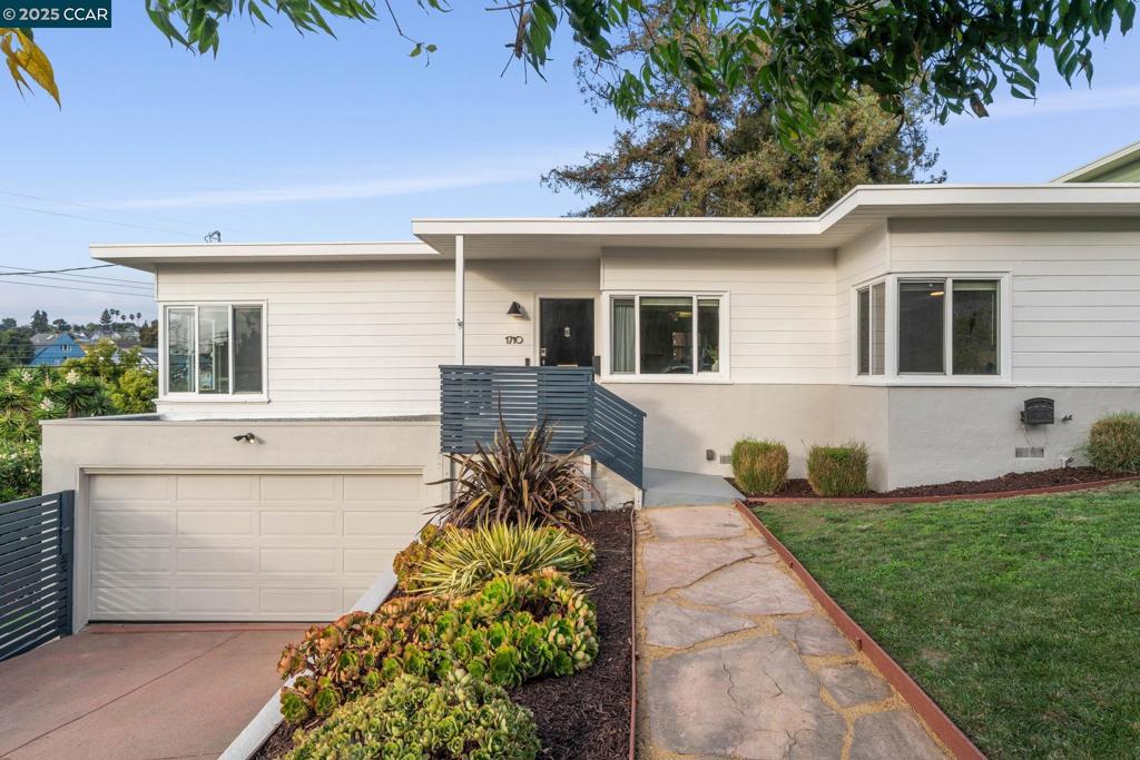 Beautifully updated single-level 3-bedroom, 2-bath mid-century home on a 6,800+ sq. ft. lot featuring multiple outdoor spaces and neighborhood views. The bright, open interior showcases a gleaming white kitchen with a functional island and adjoining dining area. Three spacious bedrooms offer ample closet space, while both bathrooms feature custom tile walls and floors. A convenient laundry area includes a stackable washer/dryer and a clever dog bath station that doubles as a folding area. Outdoors, the property unfolds across three levels designed for relaxation and entertaining. The lower terrace features mature fruit trees—avocado, apricot, and other stone fruits—beside a stylish custom chicken coop. The mid-level lawn, shaded by a towering redwood, is perfect for lounging or play. Just off the kitchen, the upper patio invites indoor-outdoor dining and evenings in the hot tub. Combining thoughtful updates, natural beauty, and versatile spaces, this Oakland gem captures the best of California living—modern comfort, timeless charm, and room to grow.