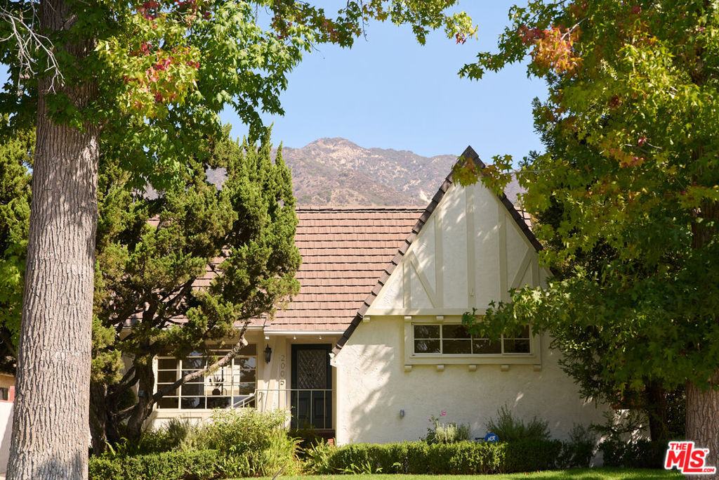 Enchanting tudor cottage in the heart of Glendale's El Miradero neighborhood. 1923 Craftsmanship offering 3bd/3bth w/ nearly 3,000 sq ft on a generous 7,500+ square foot lot. Elegant architectural details including crown moldings, pegged hardwood flooring, and original steel casement windows. Classic floor plan w/ dining room, warm kitchen w/ tile counters, gas stove, stainless steel appliances, and double ovens. Large family room with grand fireplace, built in shelving and new sisal carpet. Long breezeway gives oversized primary retreat like privacy, and features built-ins, fireplace, large walk-in closet and ensuite bath w/ marble accents, soaking tub, shower, and double sinks. 2 more bedrooms and bathrooms complete the floorplan. Multiple french doors open up to serene private courtyard w/ calming fountain and seating. Driveway w/ large attached 2-car garage + additional attic space, perfect for a bonus room or ADU conversion. The quintessential home in quiet suburban comfort.